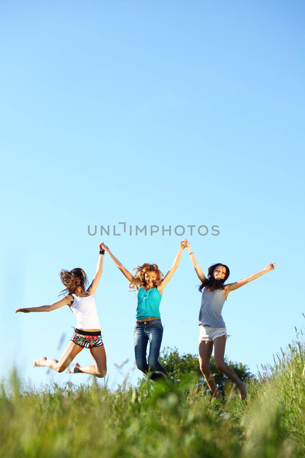 fun smile girlfriends jump to sky