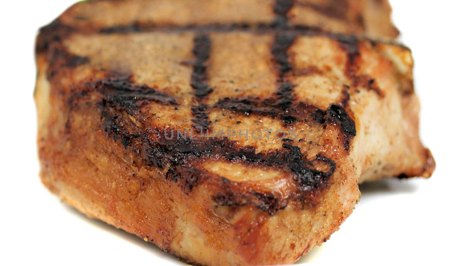 Fresh grilled beef steak on white plate close up