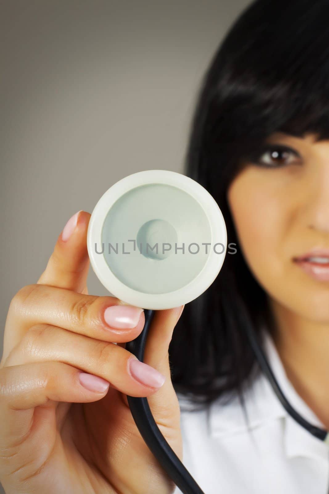 Close up - hand of a doctor holding stethoscope