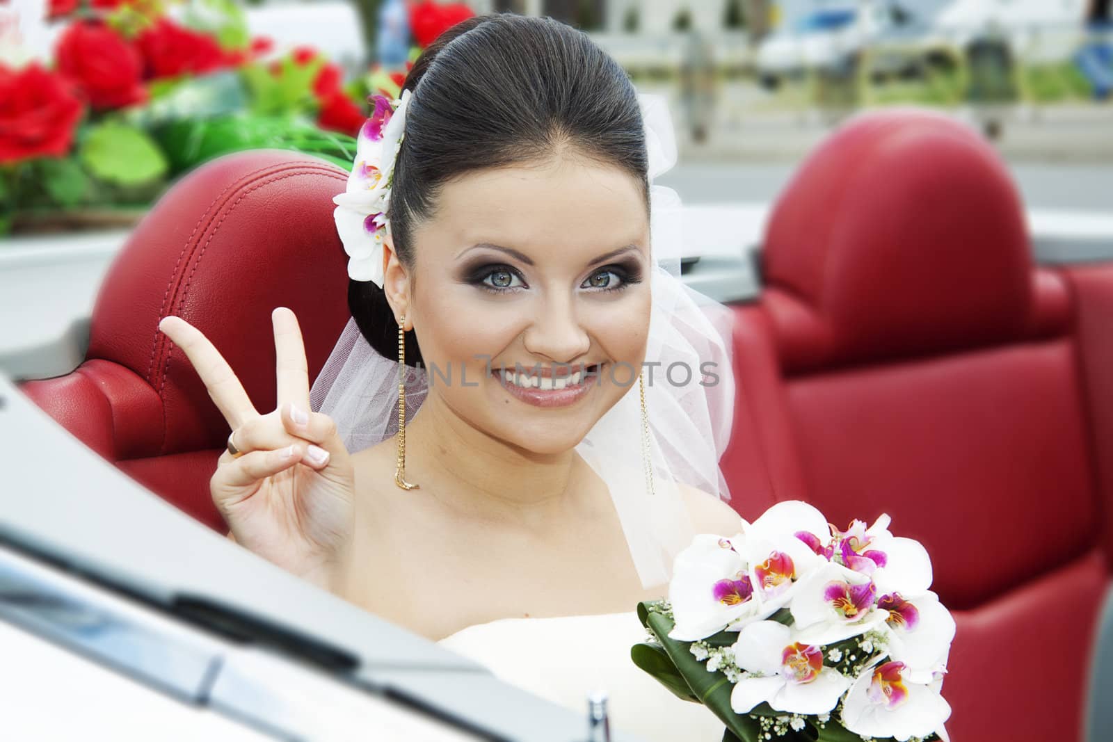Portrait of the bride sitting in the car