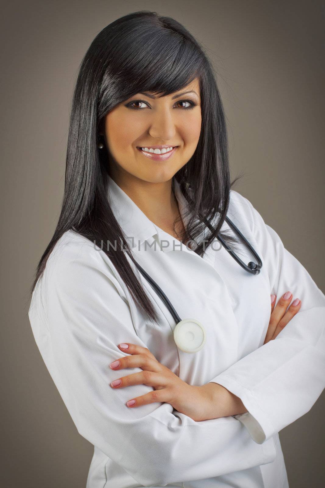 Smiling medical doctor with stethoscope by ozaiachin