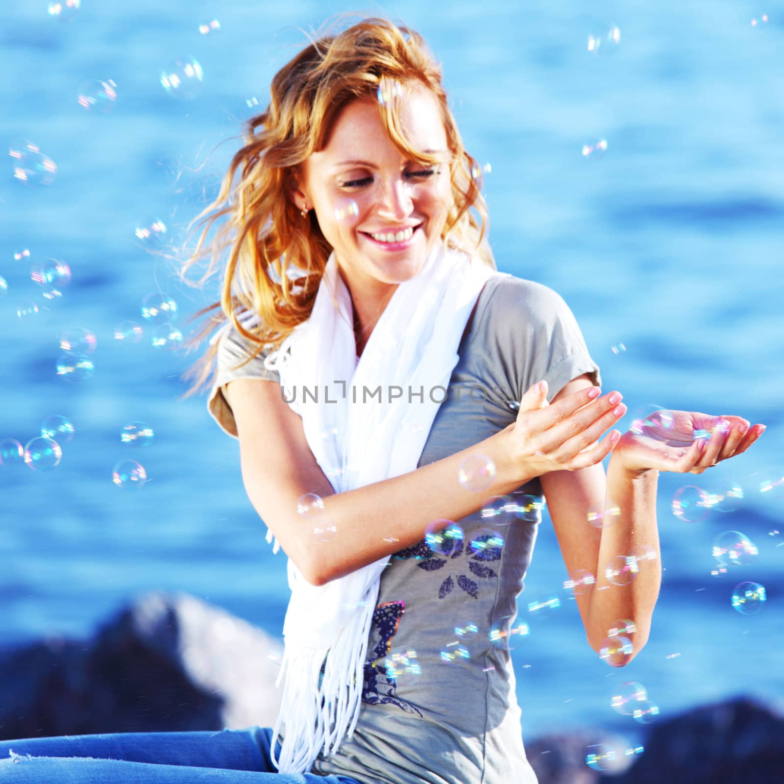 happy blond hair woman sea on background