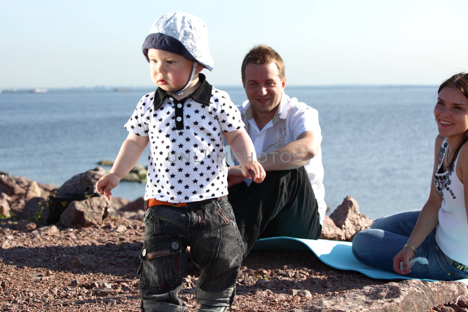 happy family on picnic sea on background