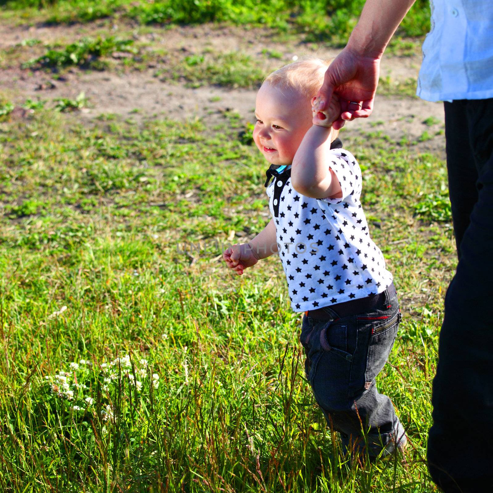 father and son walking on grass