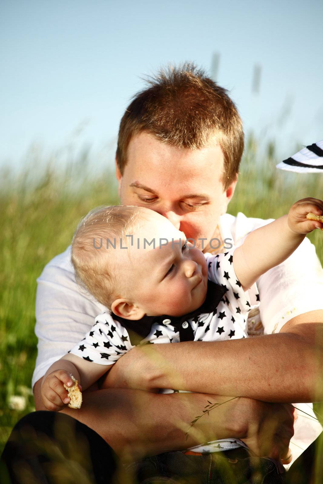 father and son in green grass