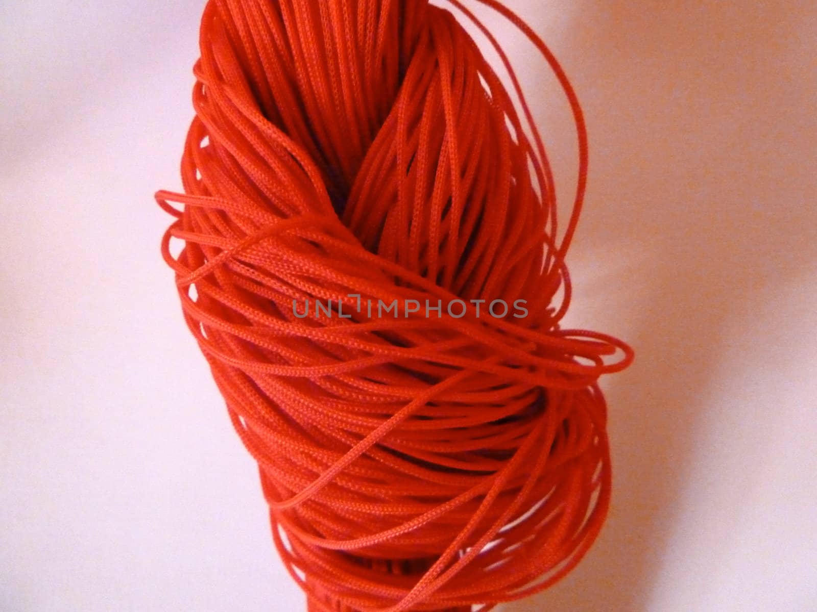 red string knot on a white background