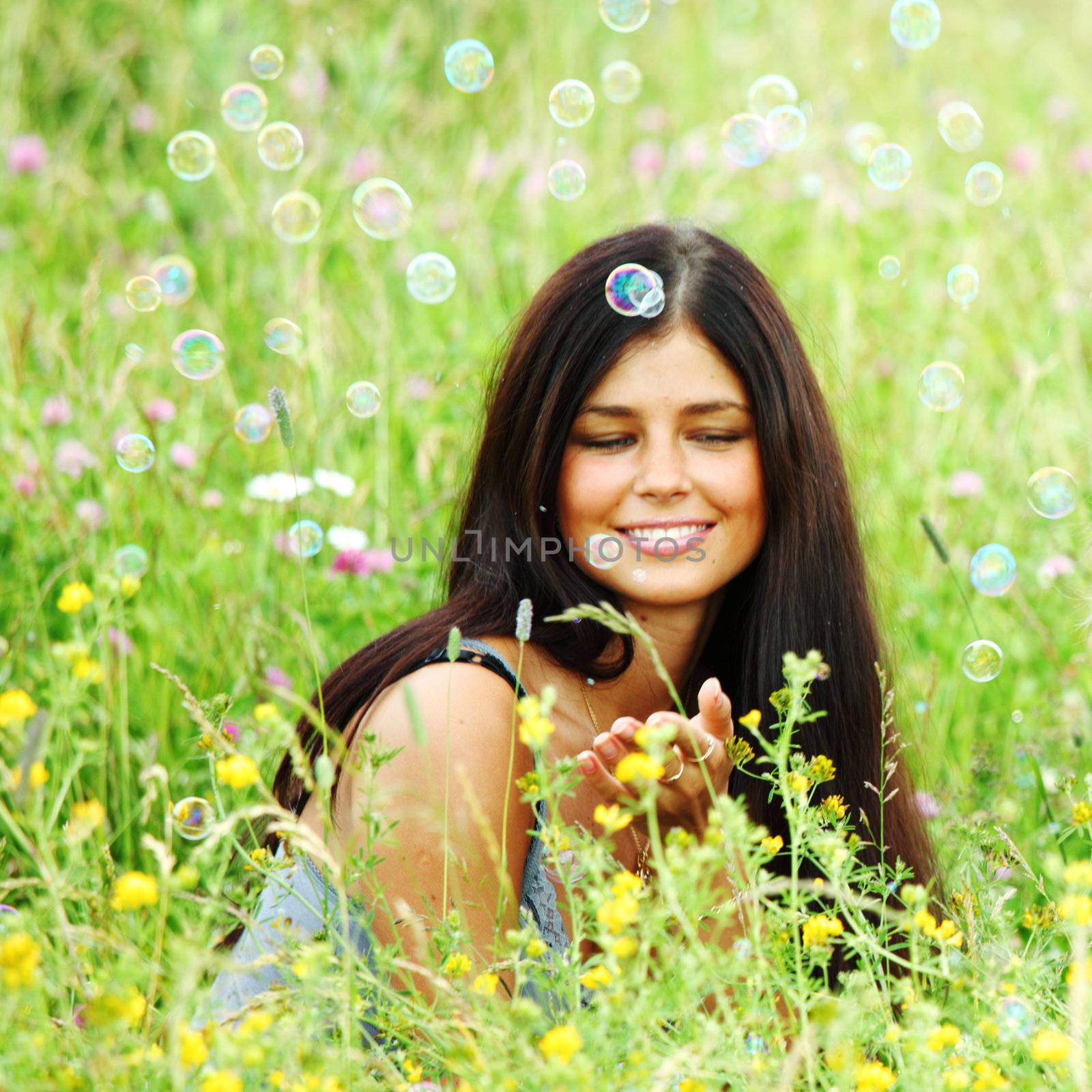 girlfriends on green grass field in soap bubbles