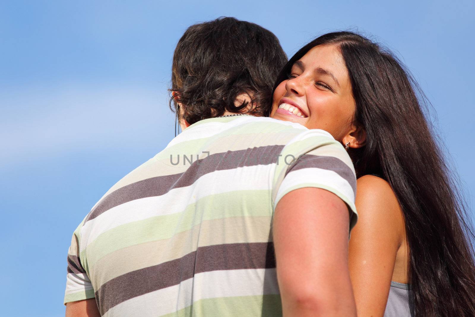 man and woman hug sky on background
