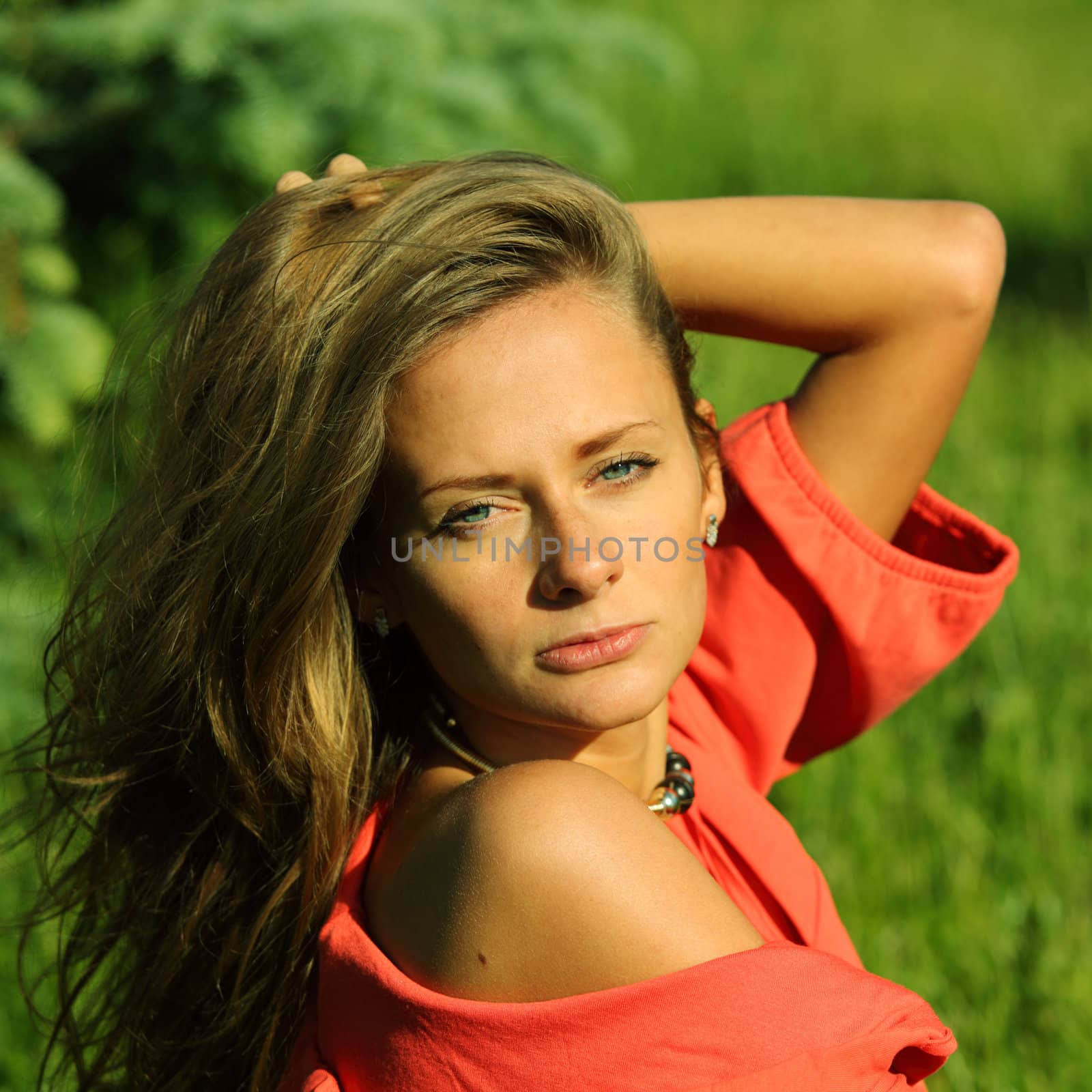 young sommer woman on green grass