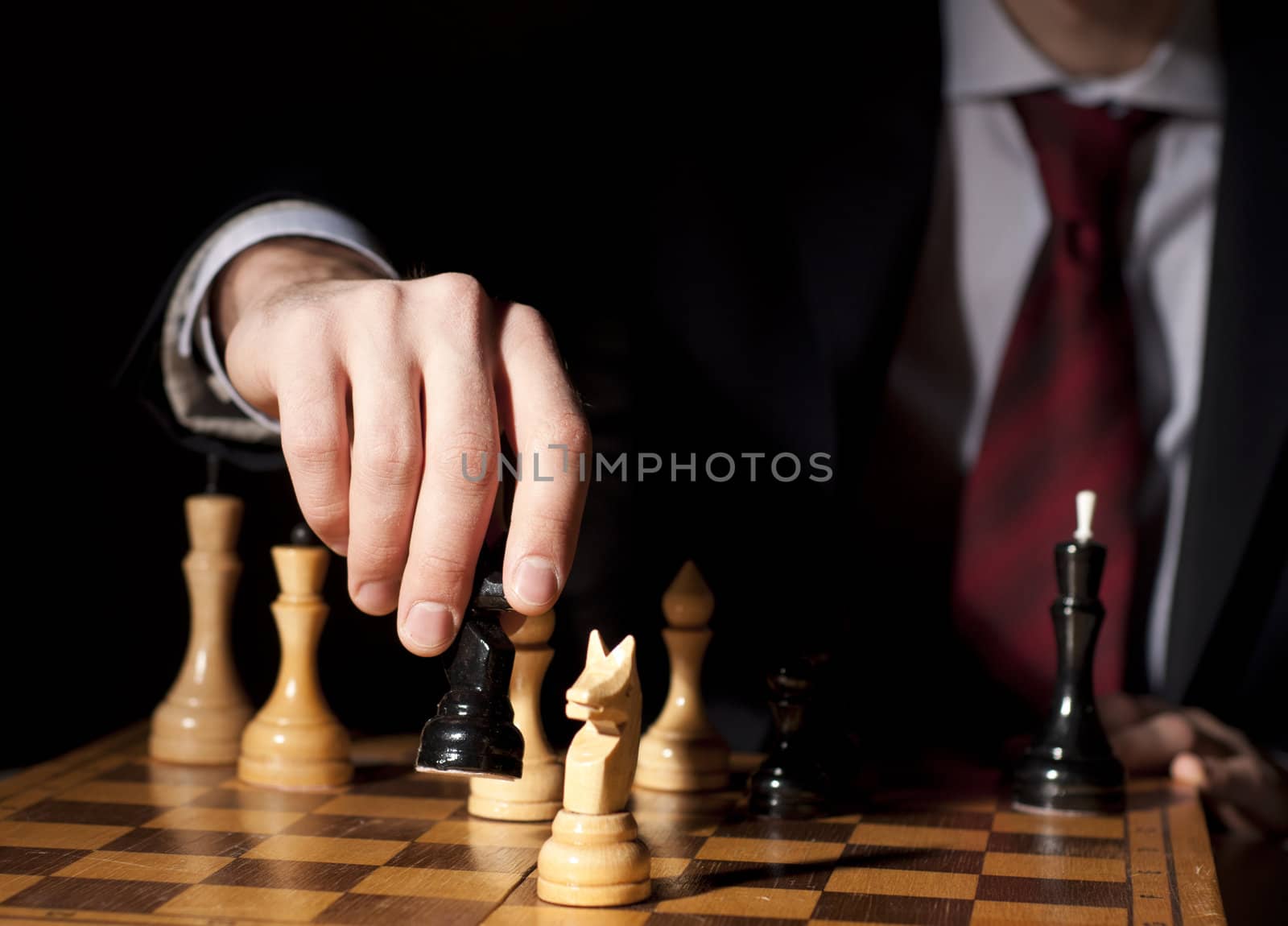 image of the businessman in a business suit plays chess