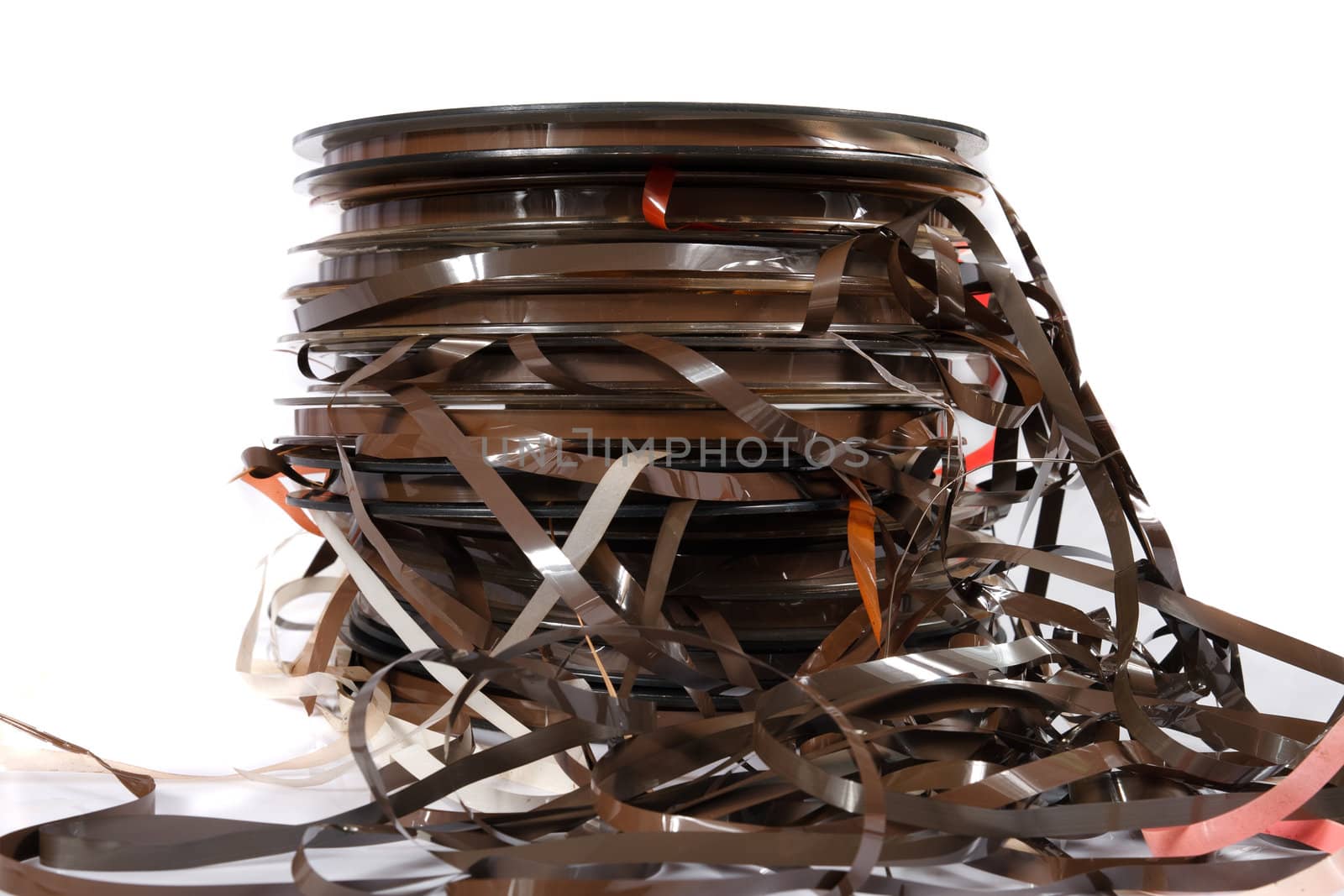 stack of old magnetic tapes on white