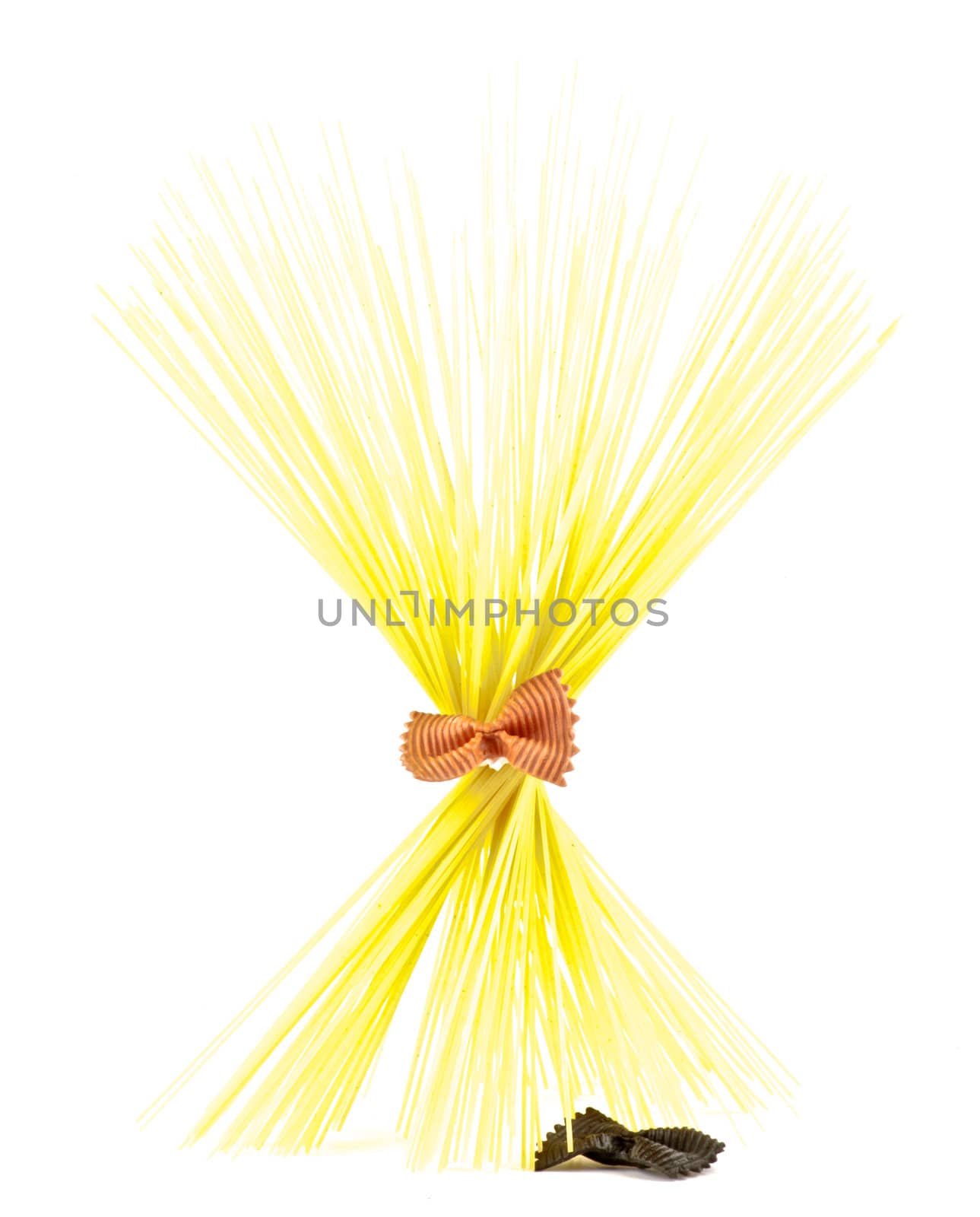 Bunch of spaghetti with red farfalle isolated on white background
