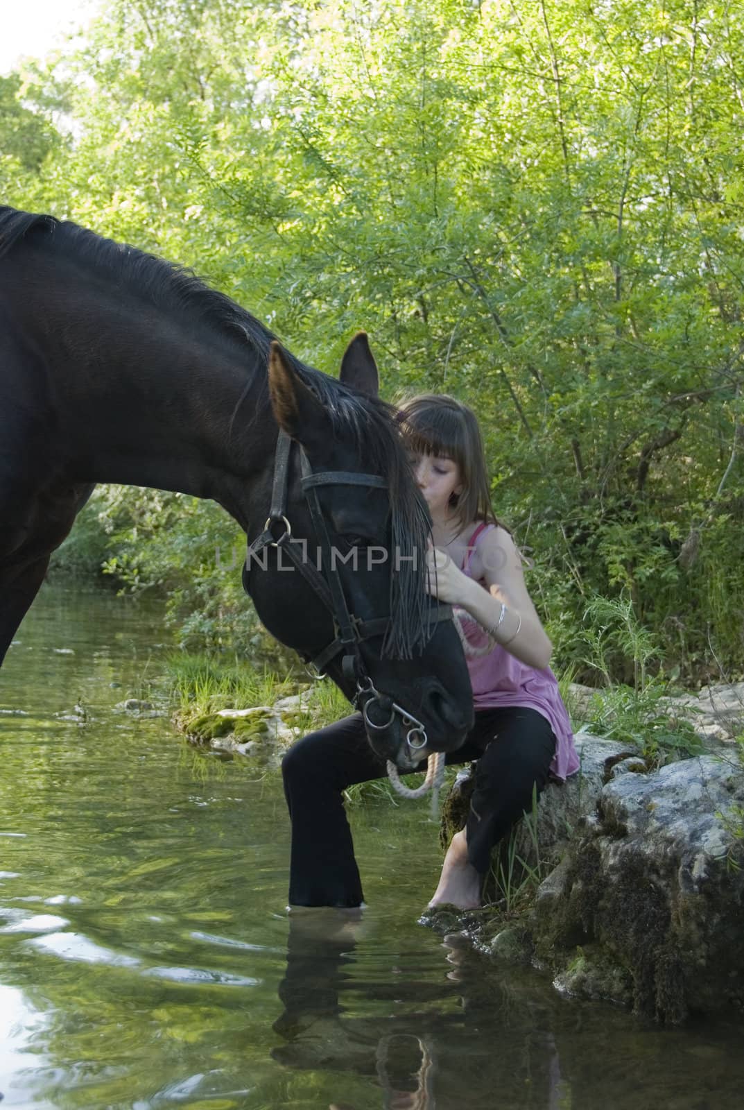 child and horse in river by cynoclub