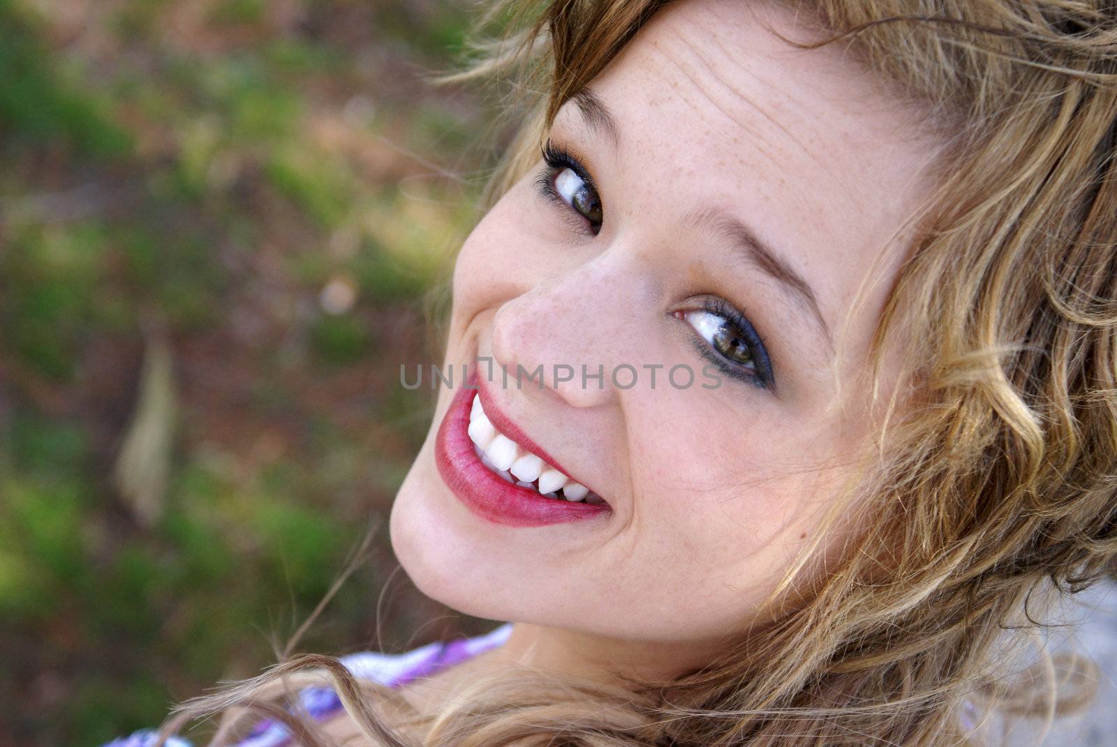A young woman smiles happily at the viewer.