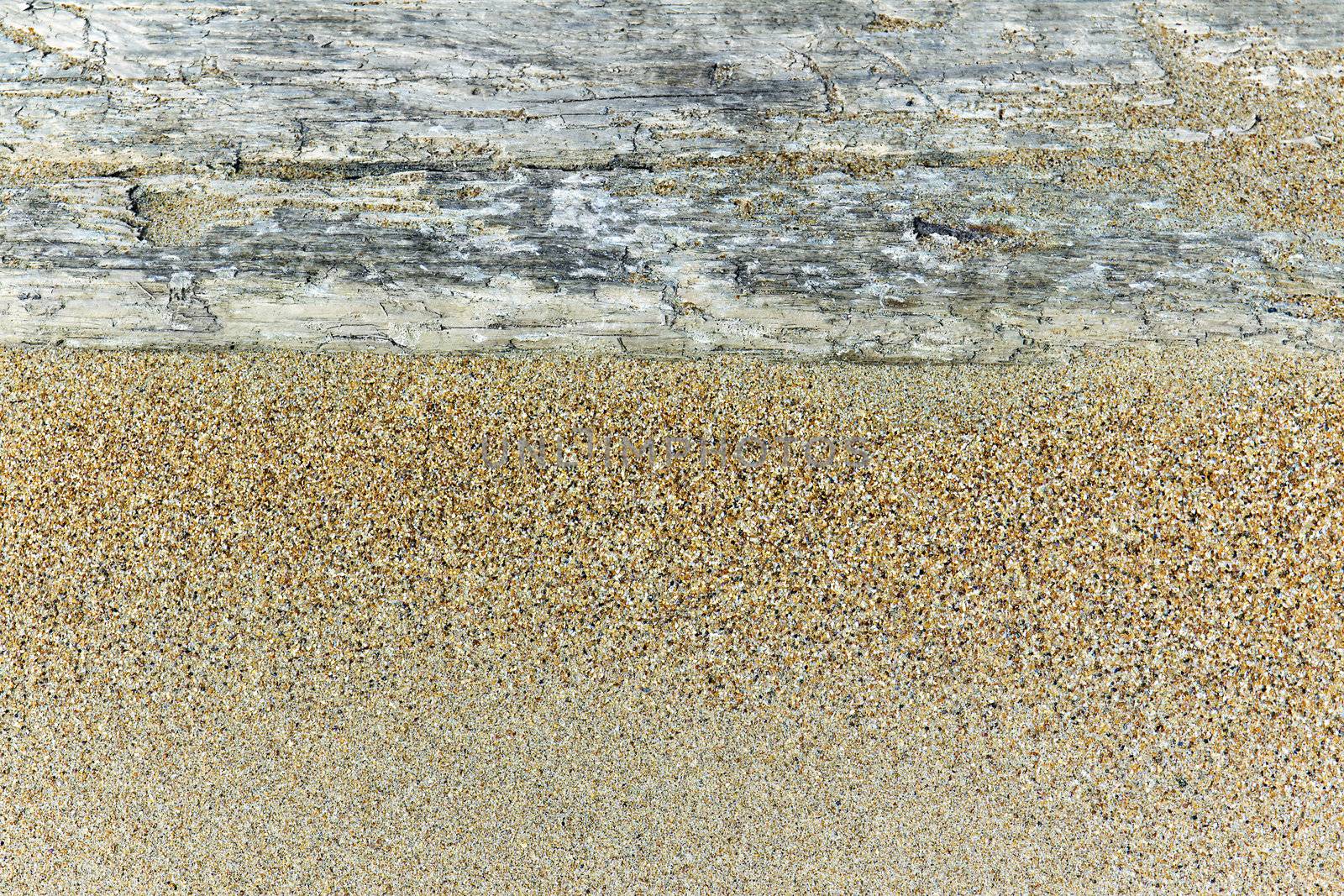 an old wooden board in the sand as the background