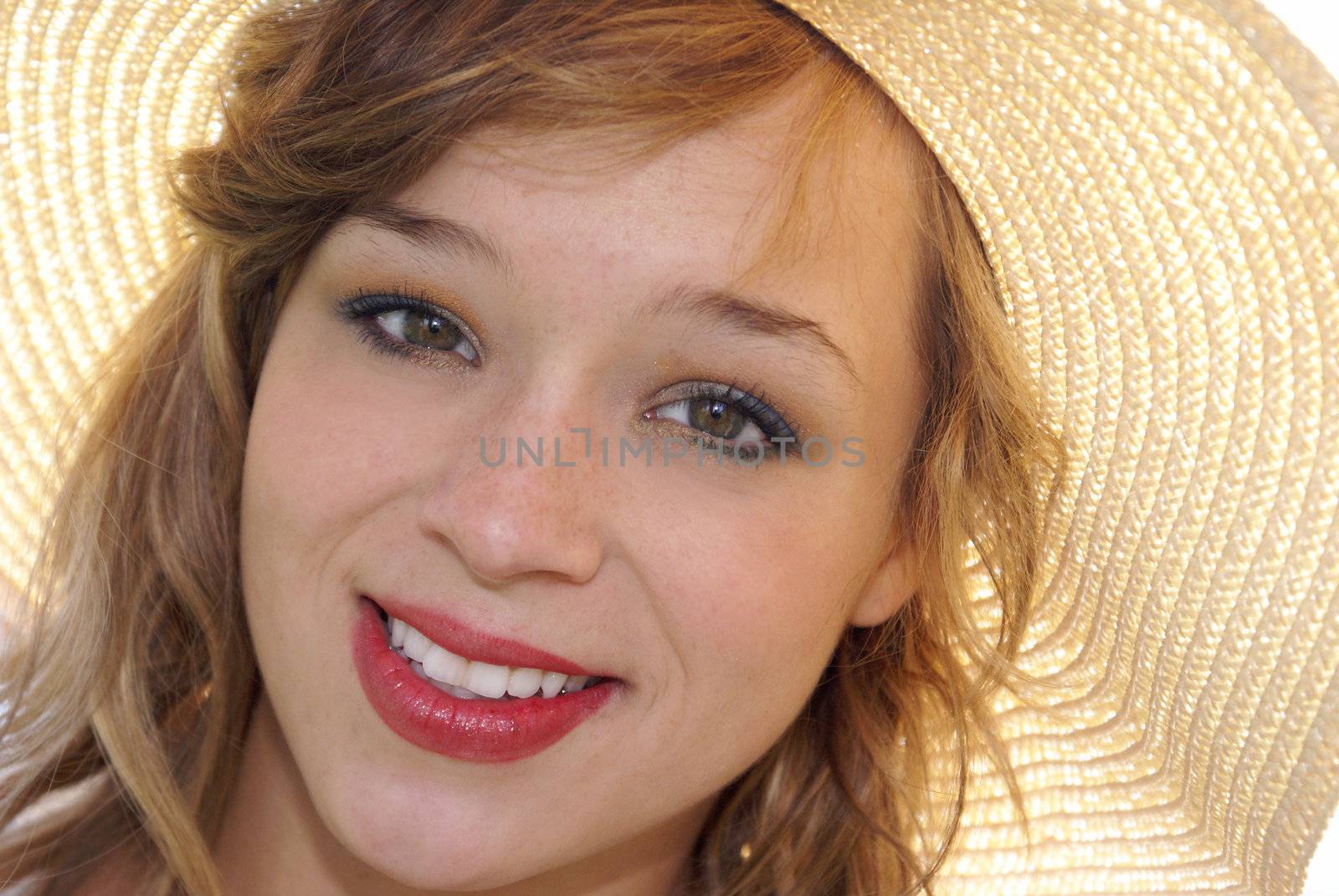 A closeup of a young Woman in a sun hat.