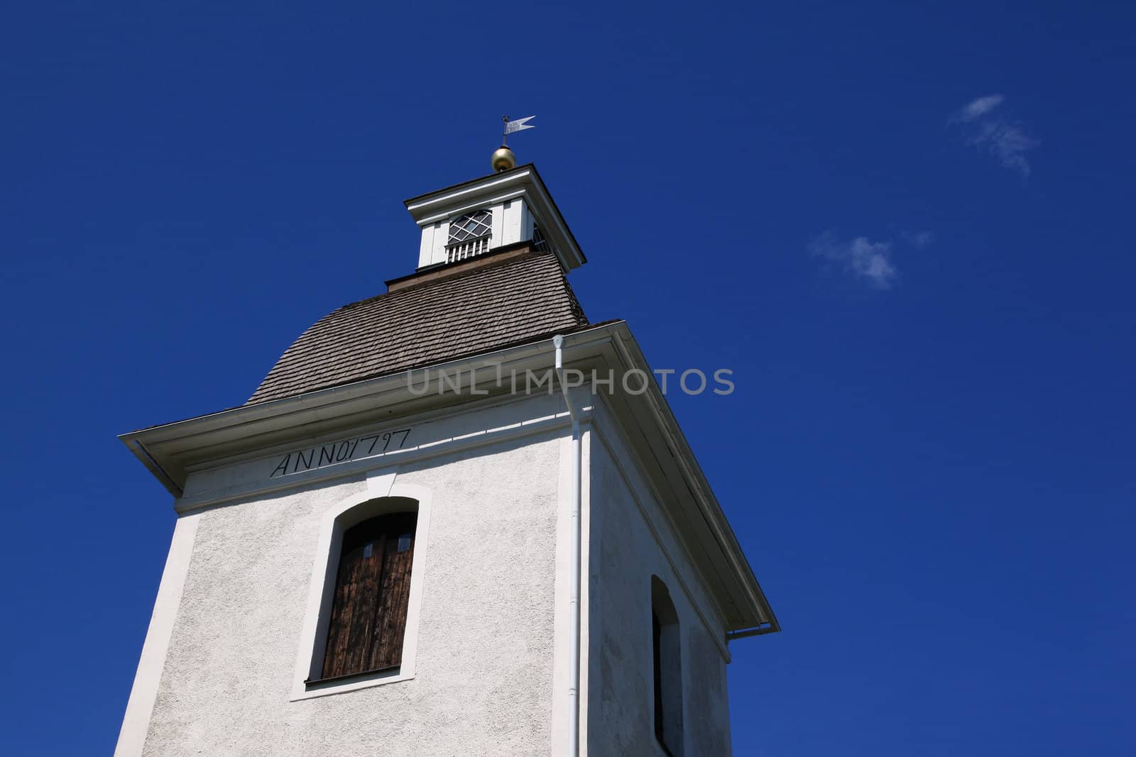 A white tower of a church built in late eighteenth century in Ostergotland, Sweden. 