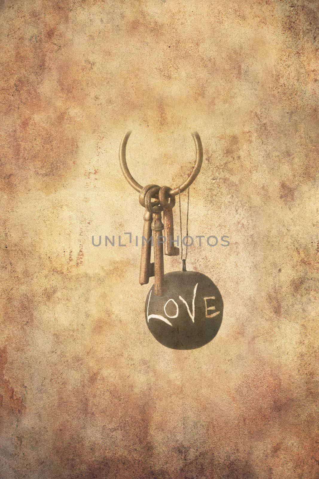 Set of three rusty keys in an open ring together with a ball in slate hanging freely with the message love written by hand with chalk, in grunge style.