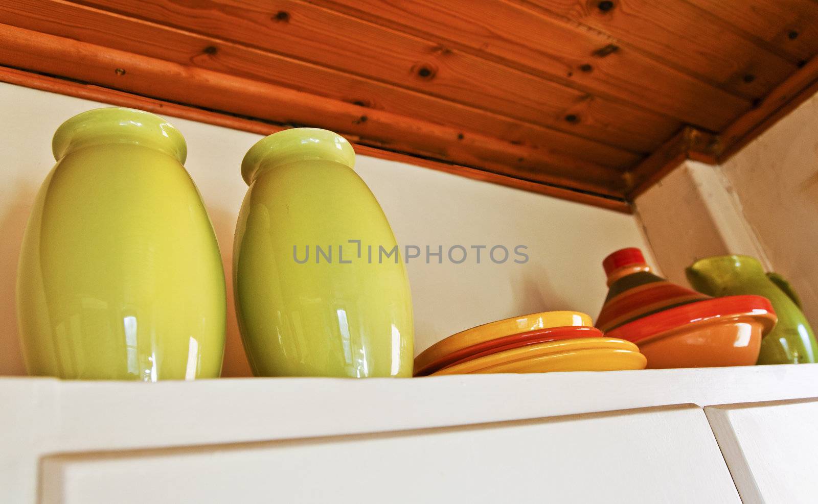 Interior design of English cottage showing top of a corner cupboard used to house kitchen utensils