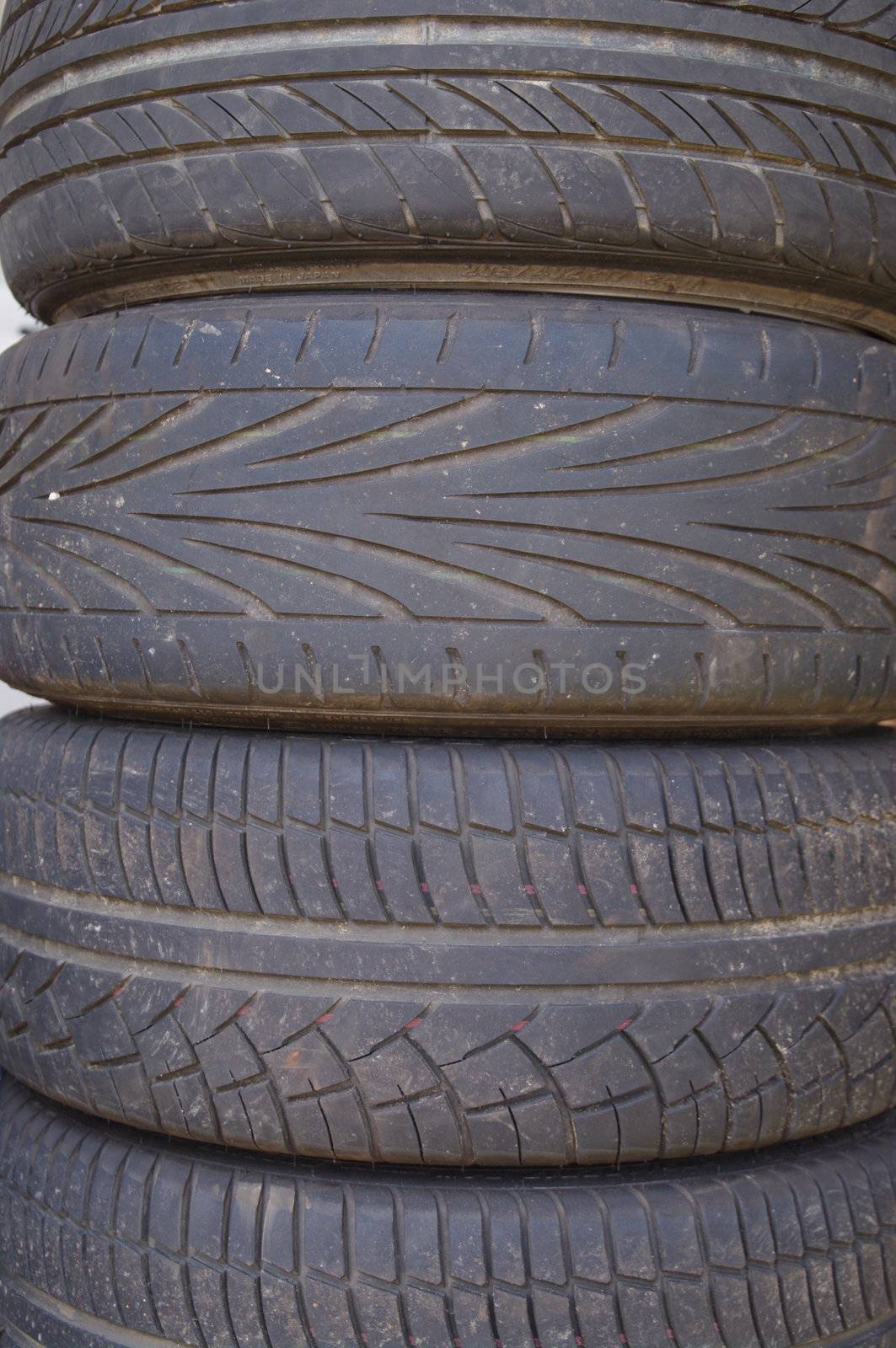 stack of used car wheels