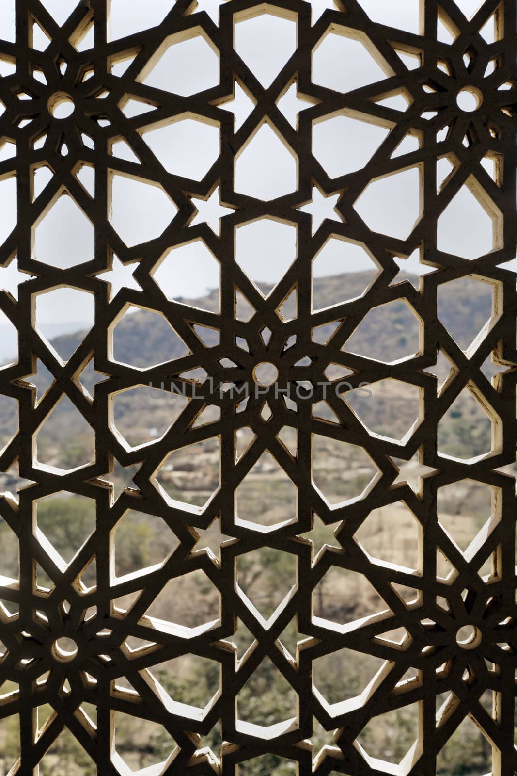 Indigenous concrete craftwork of Rajasthan India on a window opening, grid design allows air and light circulation but prevents the nesting of birds