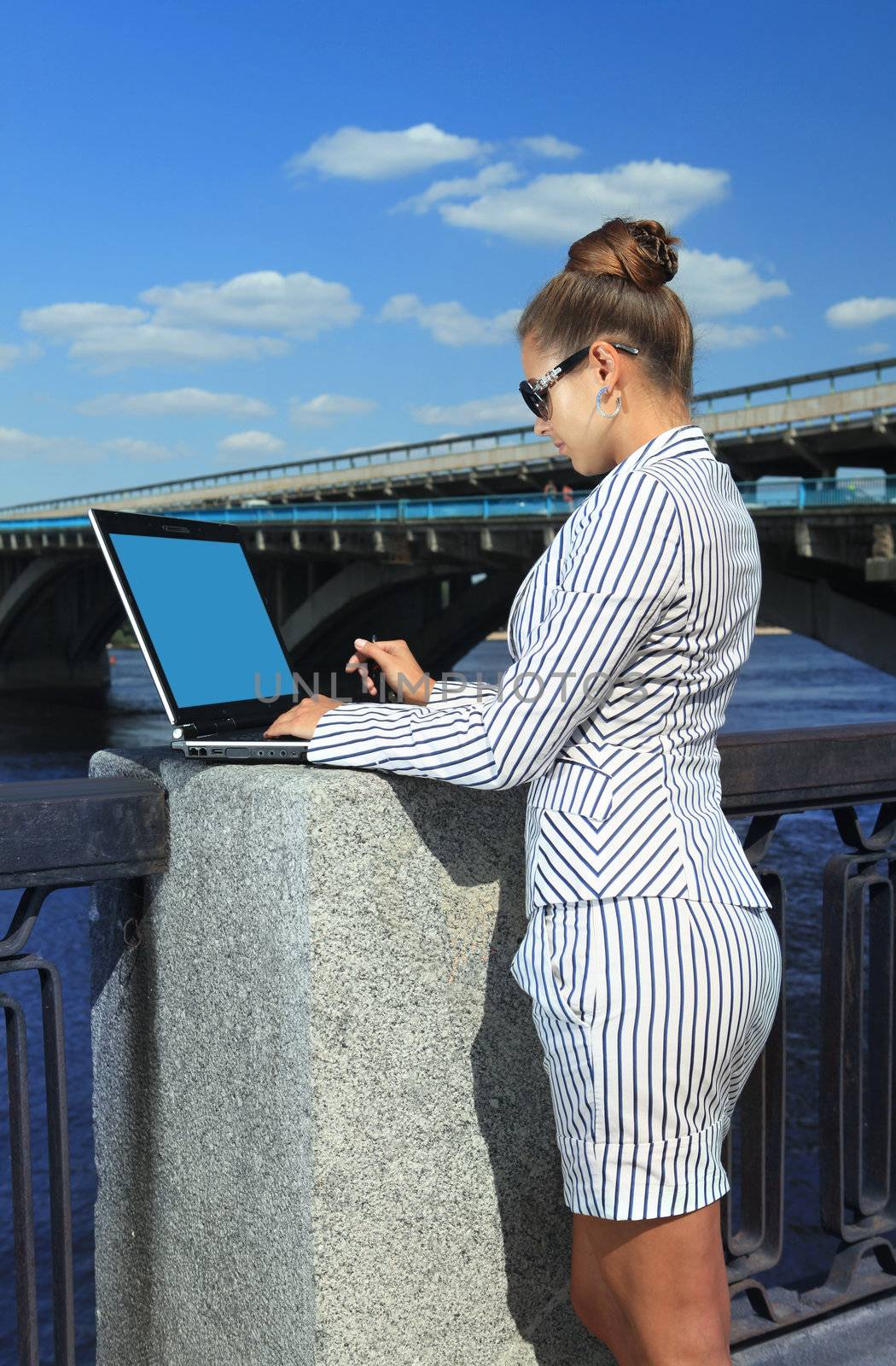 beautiful woman with the laptop on city quay