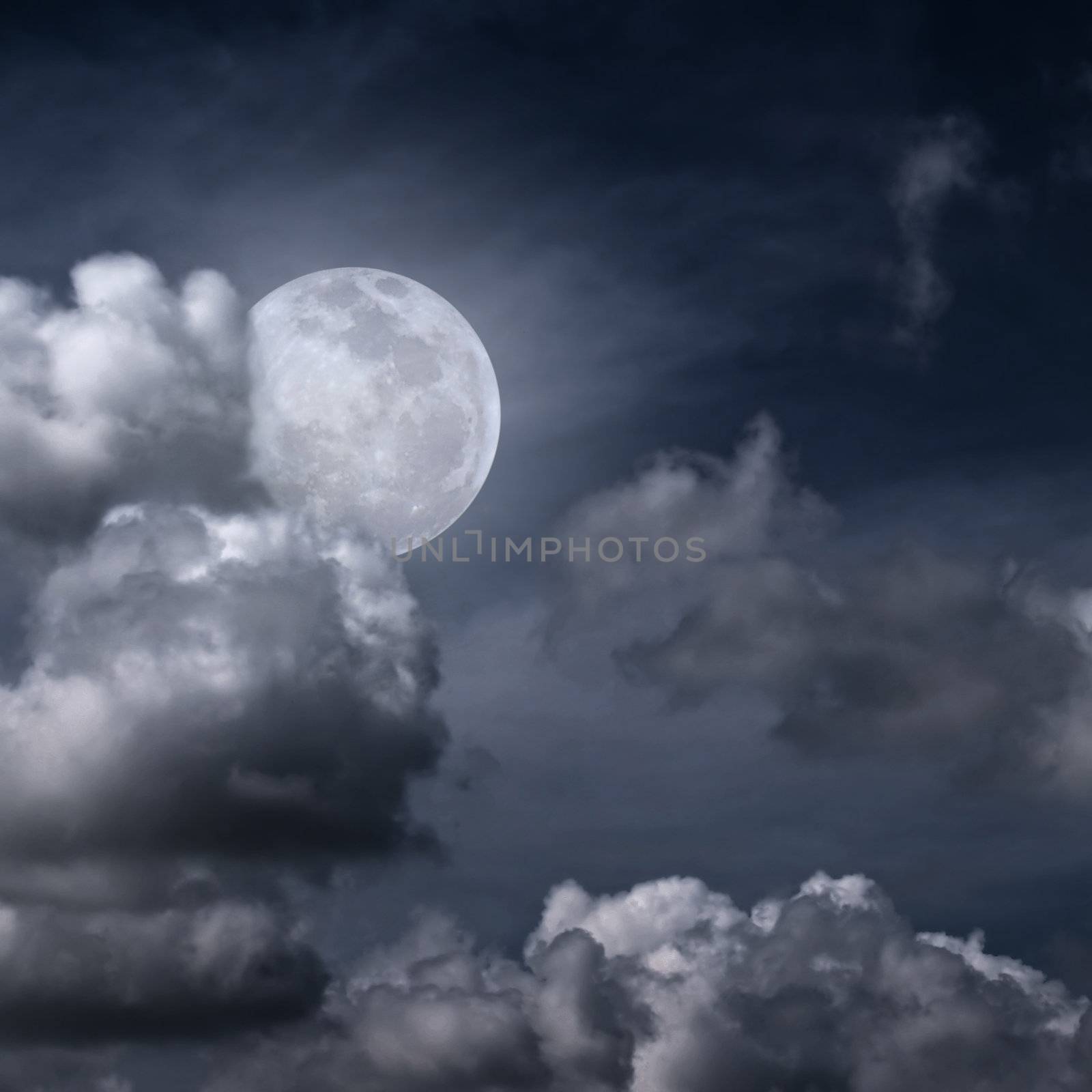 Beautiful full moon behind fantasy cloudy sky