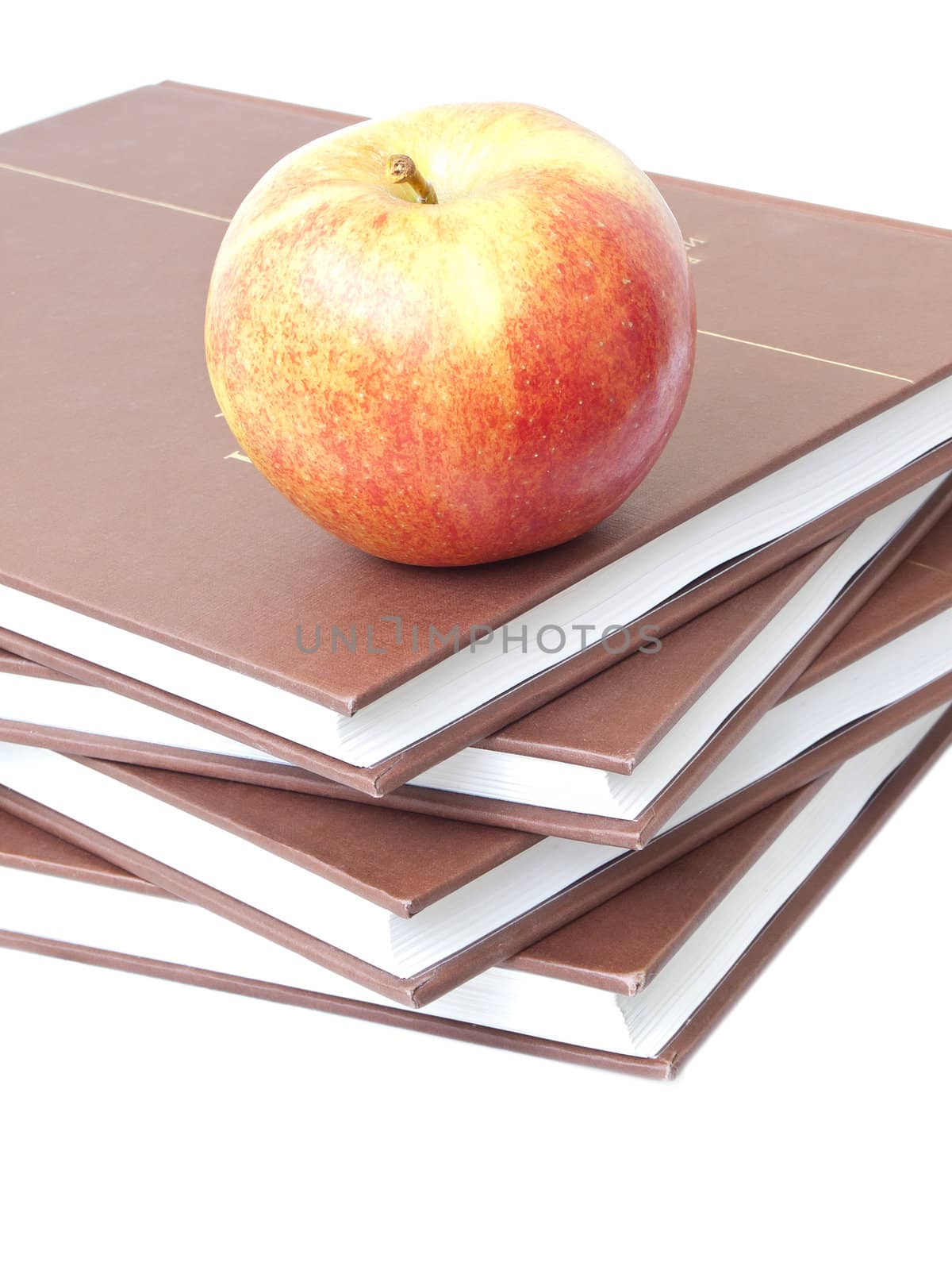 Isolated apple on a stack of four books