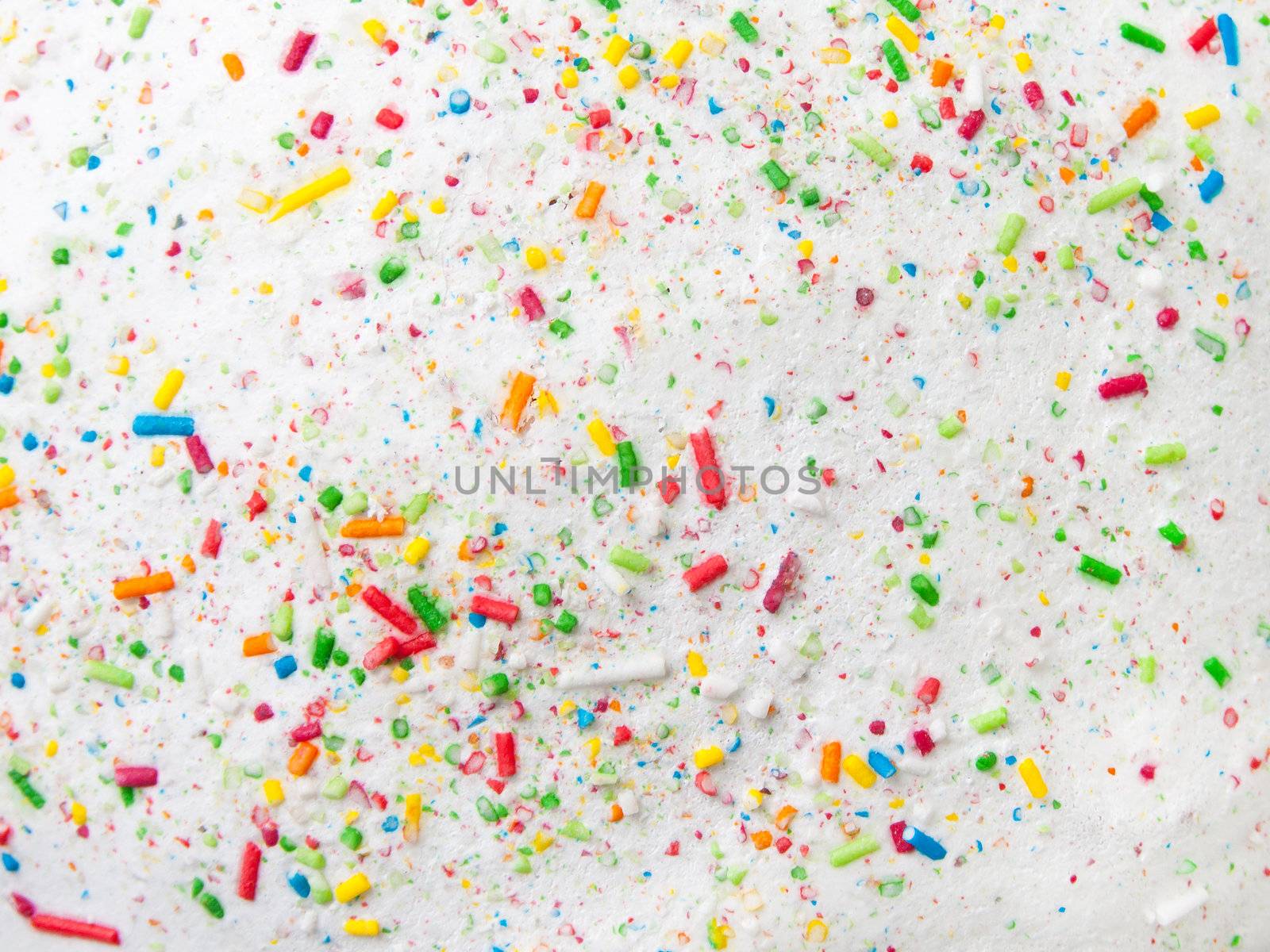 Confectionery decoration confetti on a white sugar glaze 