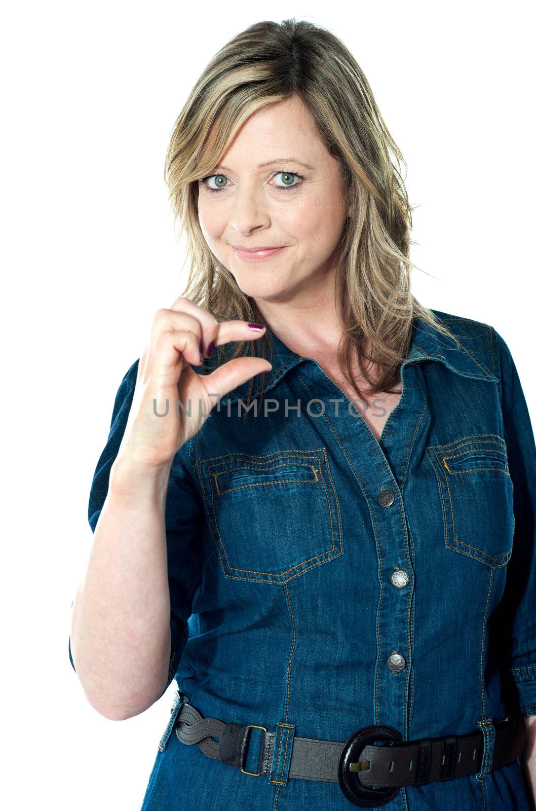 Female indicating little bit gesture against white background
