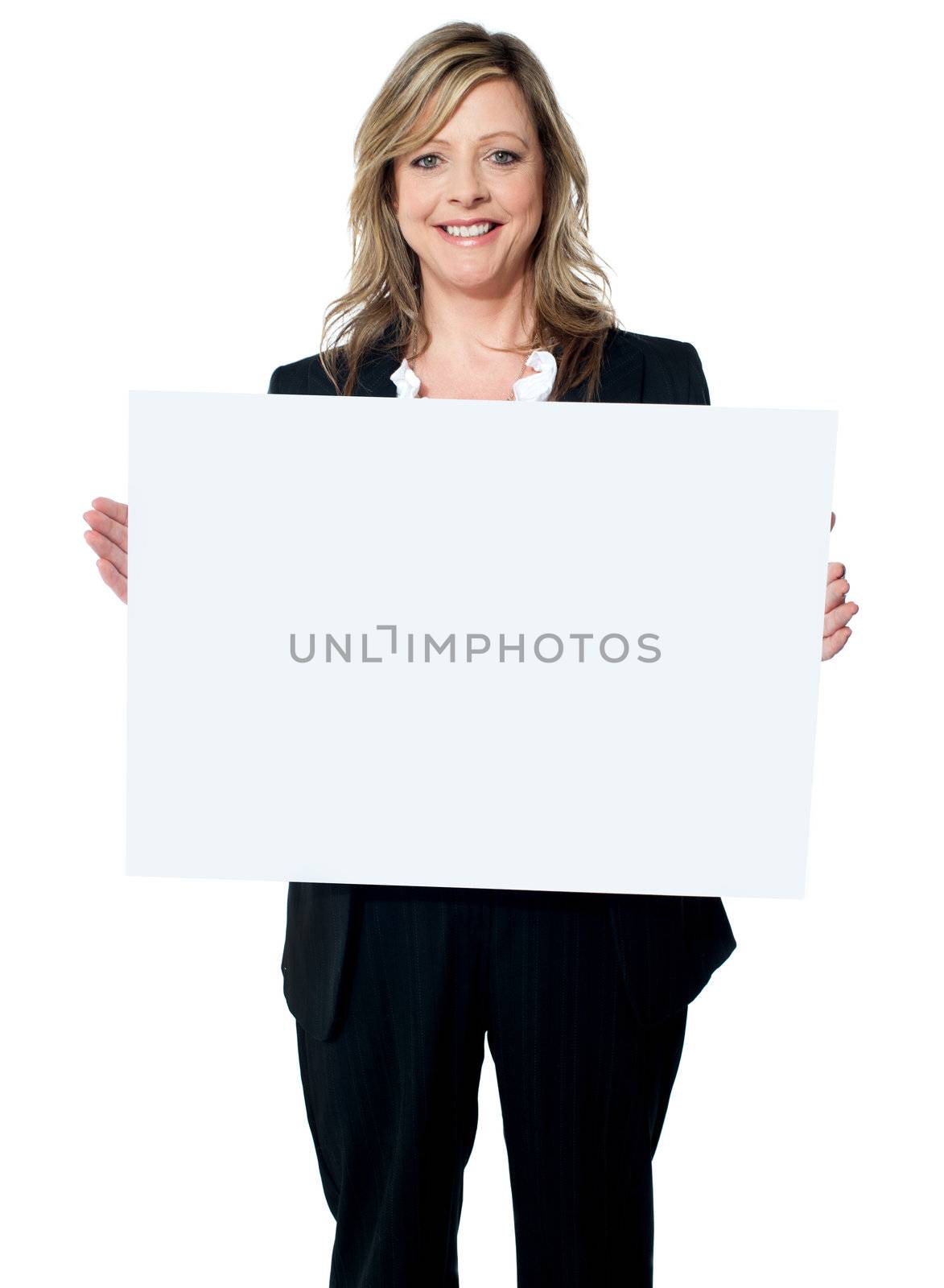 Smiling woman holding a blank billboard by stockyimages