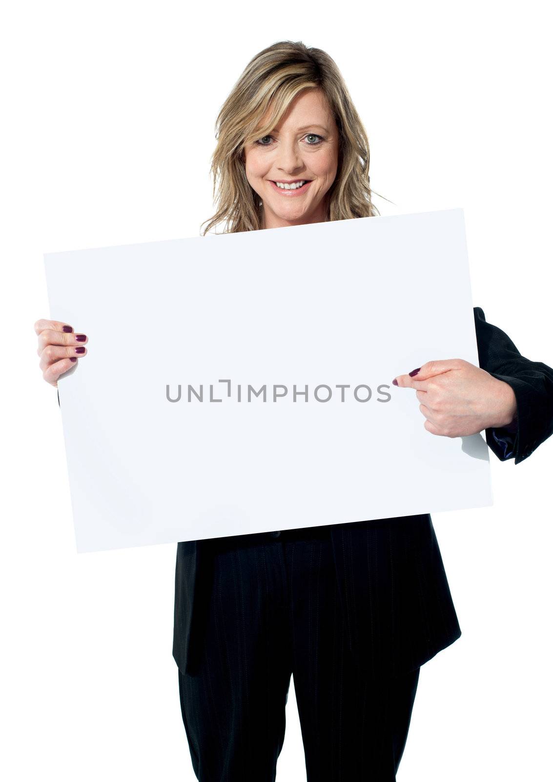 Beautiful woman pointing at the blank billboard by stockyimages