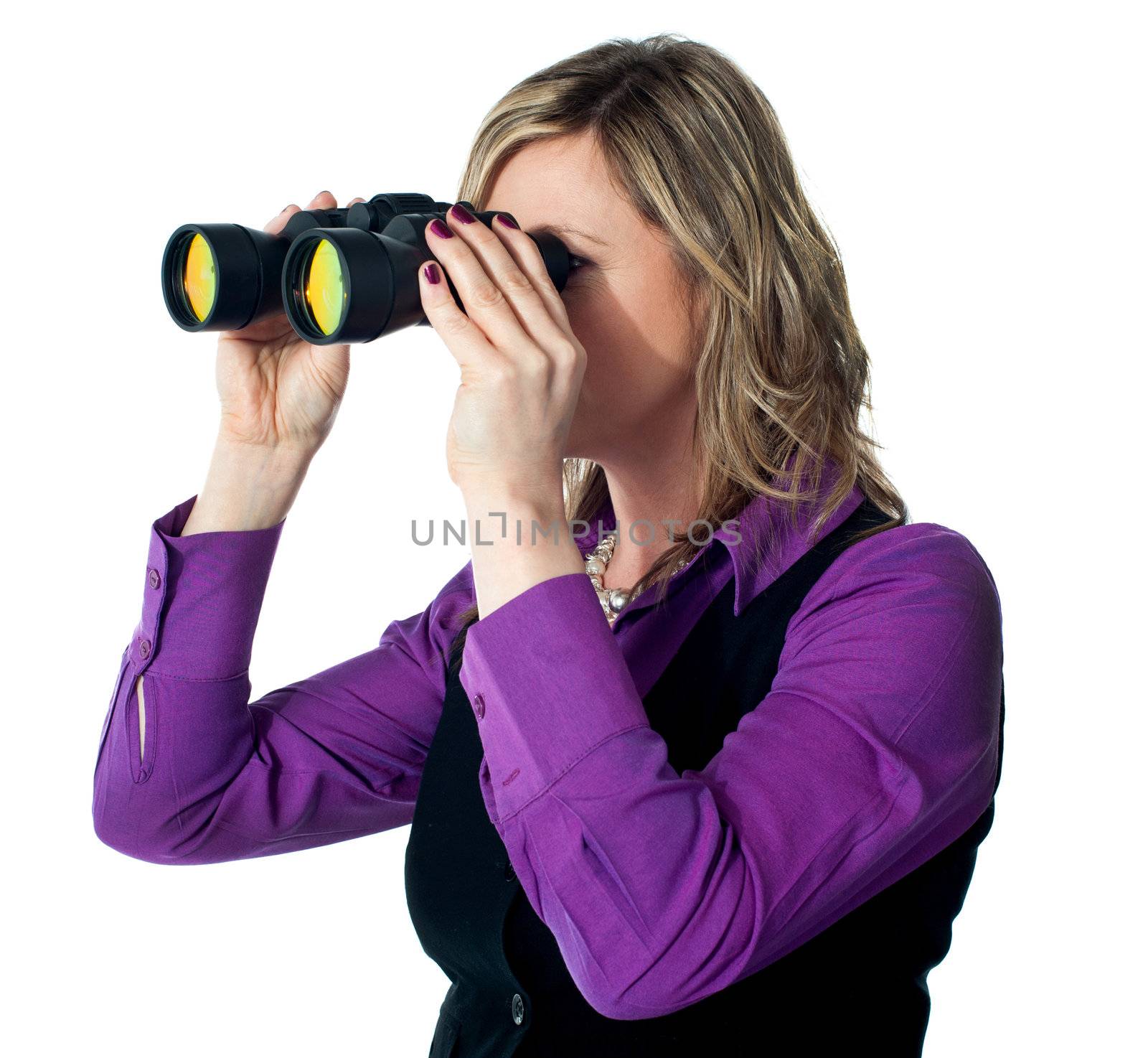 Businesswoman looking through binoculars by stockyimages