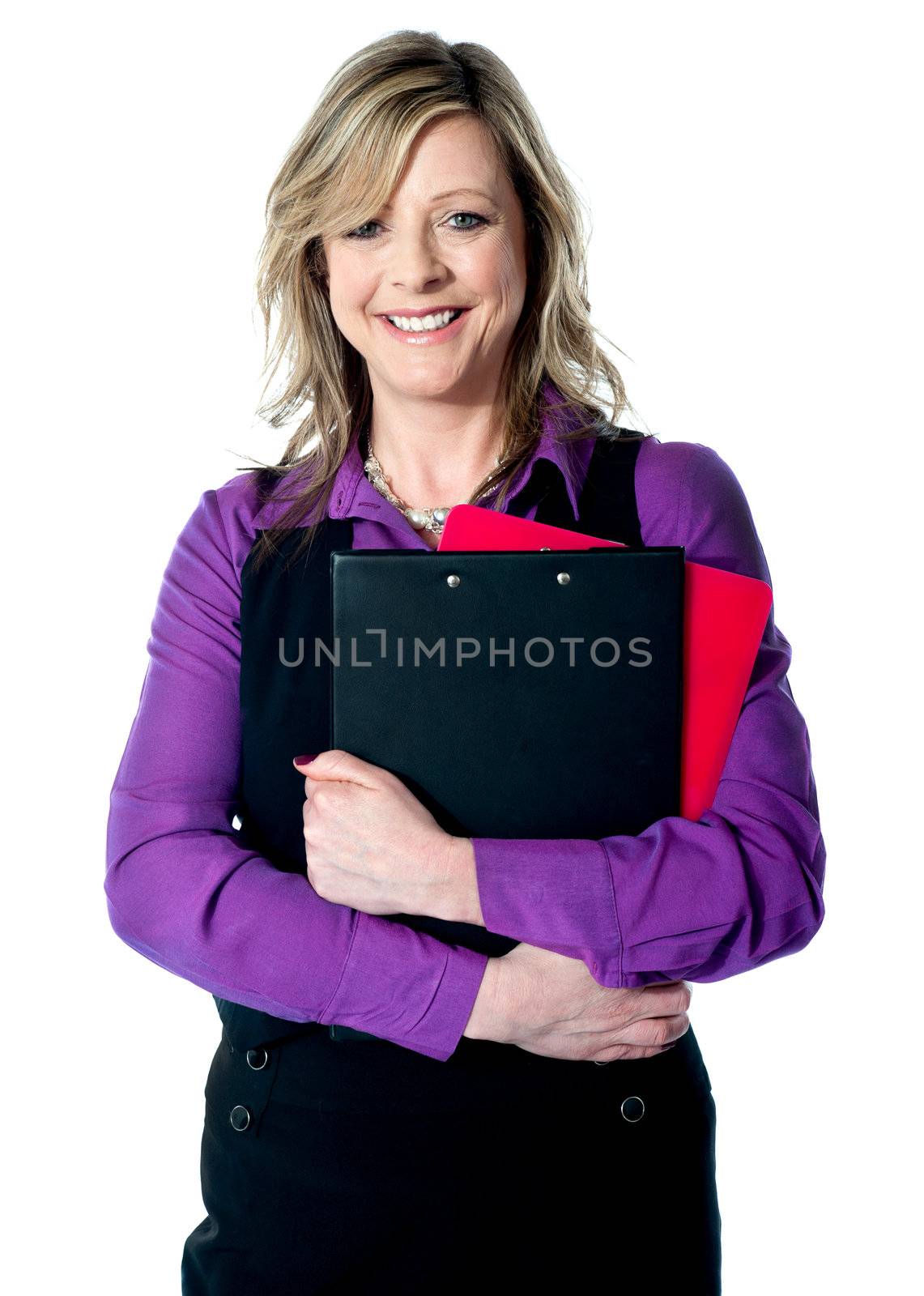 Corporate woman holding documents tightly, smiling at camera