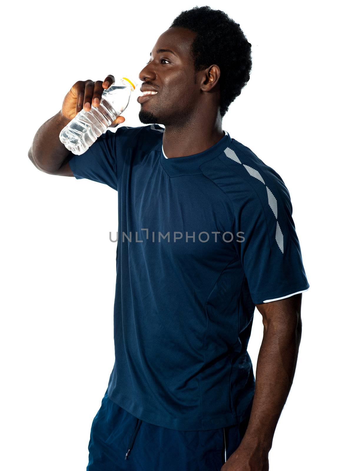Tired african athlete drinking water against white background