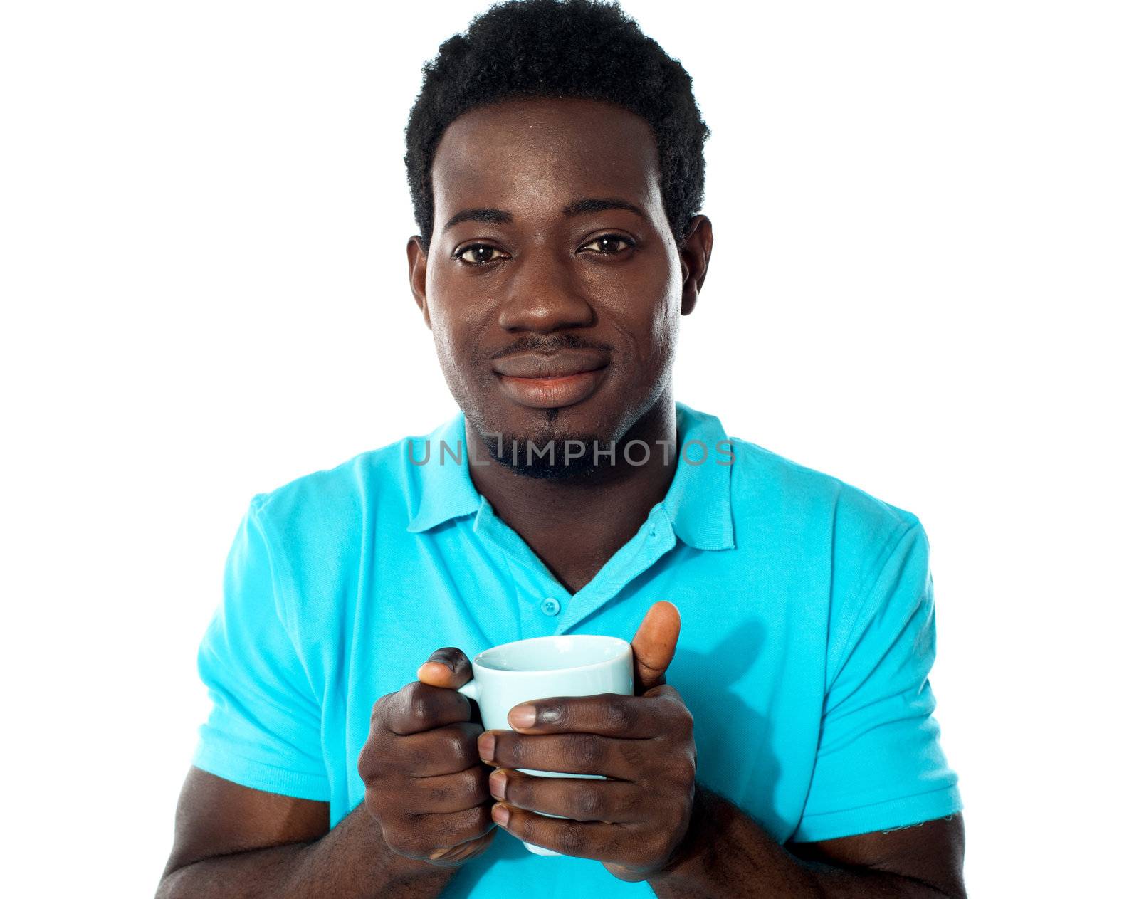 African guy holding coffee mug by stockyimages