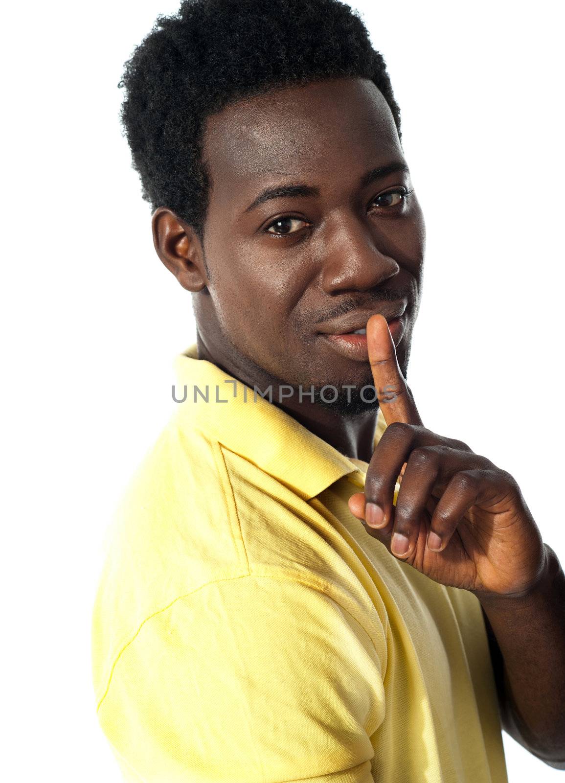 Handsome young guy gesturing silence isolated over white