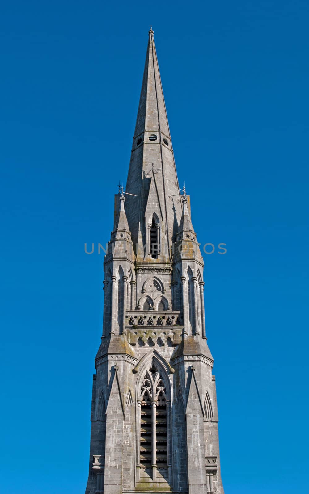 tower detail of Saint John's cathedral in Limerick, Ireland (blue sky background)