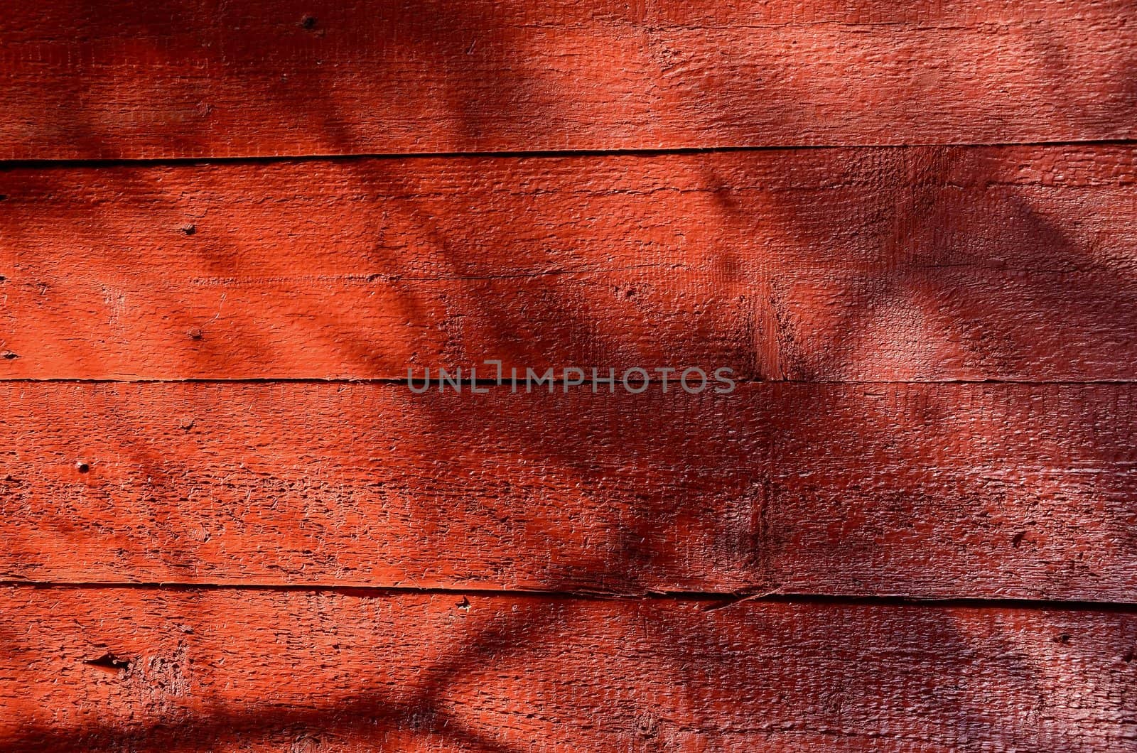 Shadows on red-painted wooden wall. by sauletas