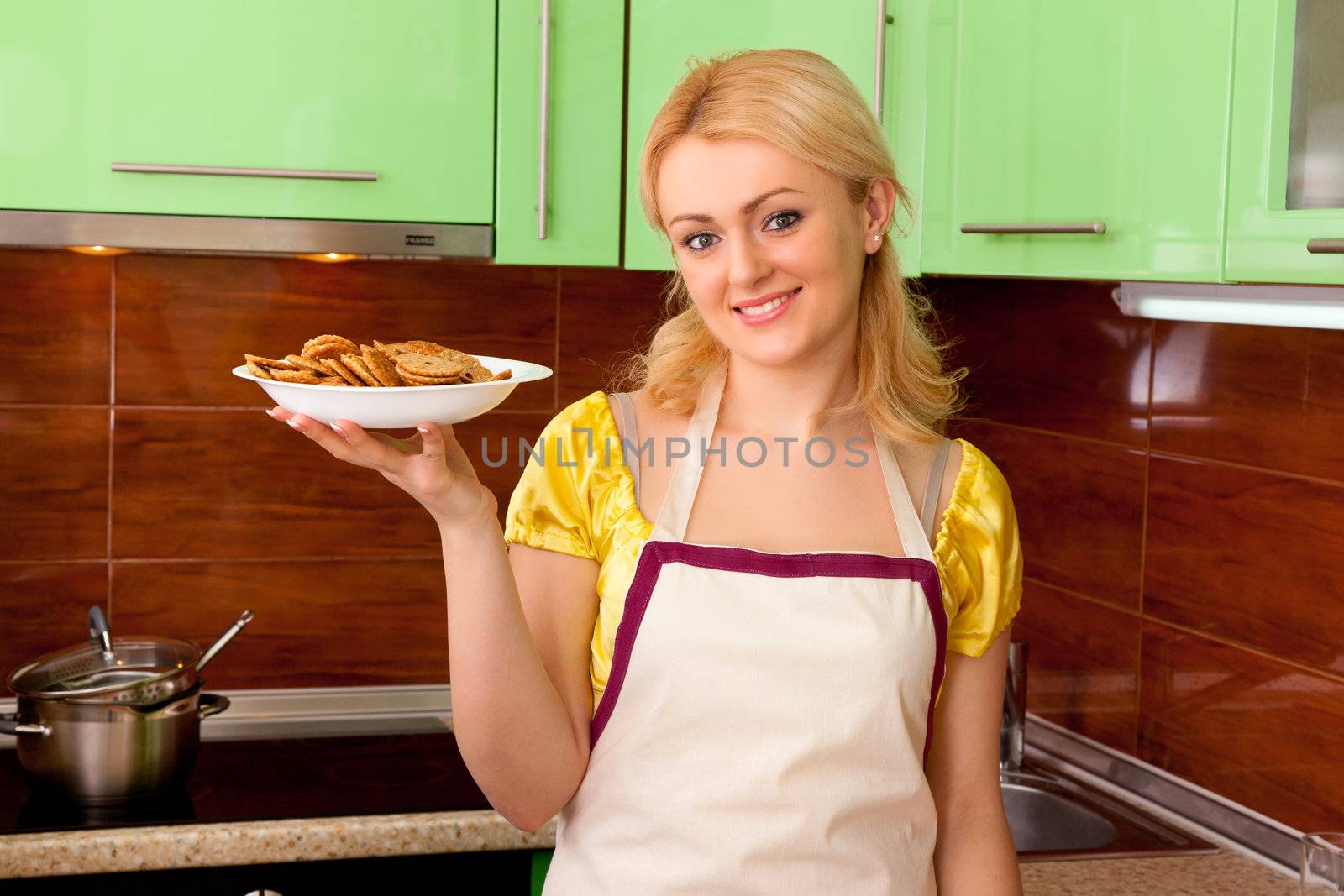 Young housewife cooked meal in kitchen interior