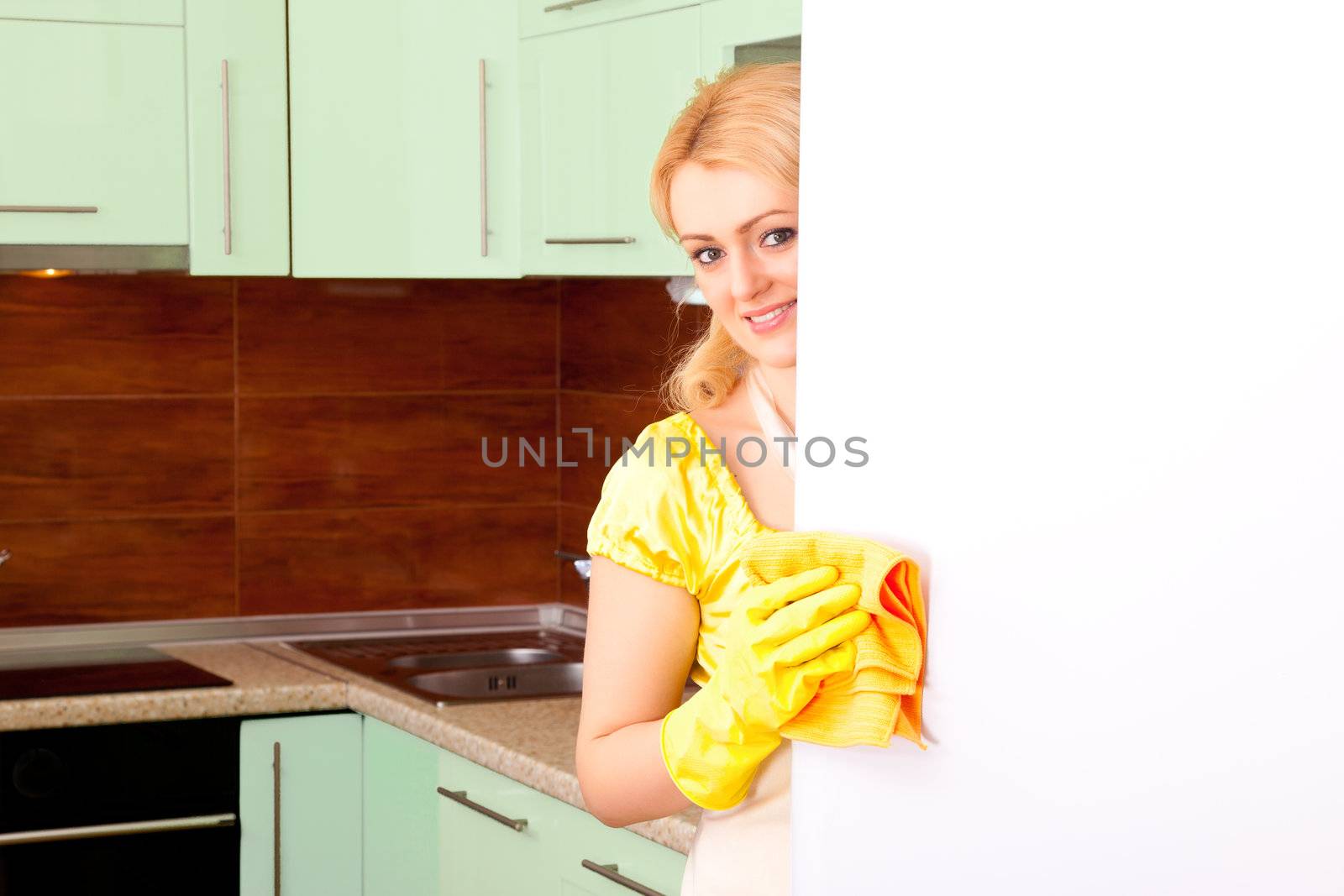 young attractive woman clean the kitchen ( green color )