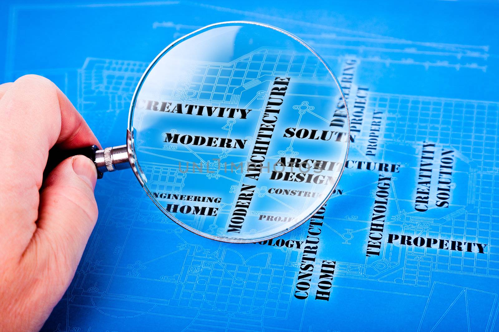 human hand with a magnifying glass on the art architectural background
