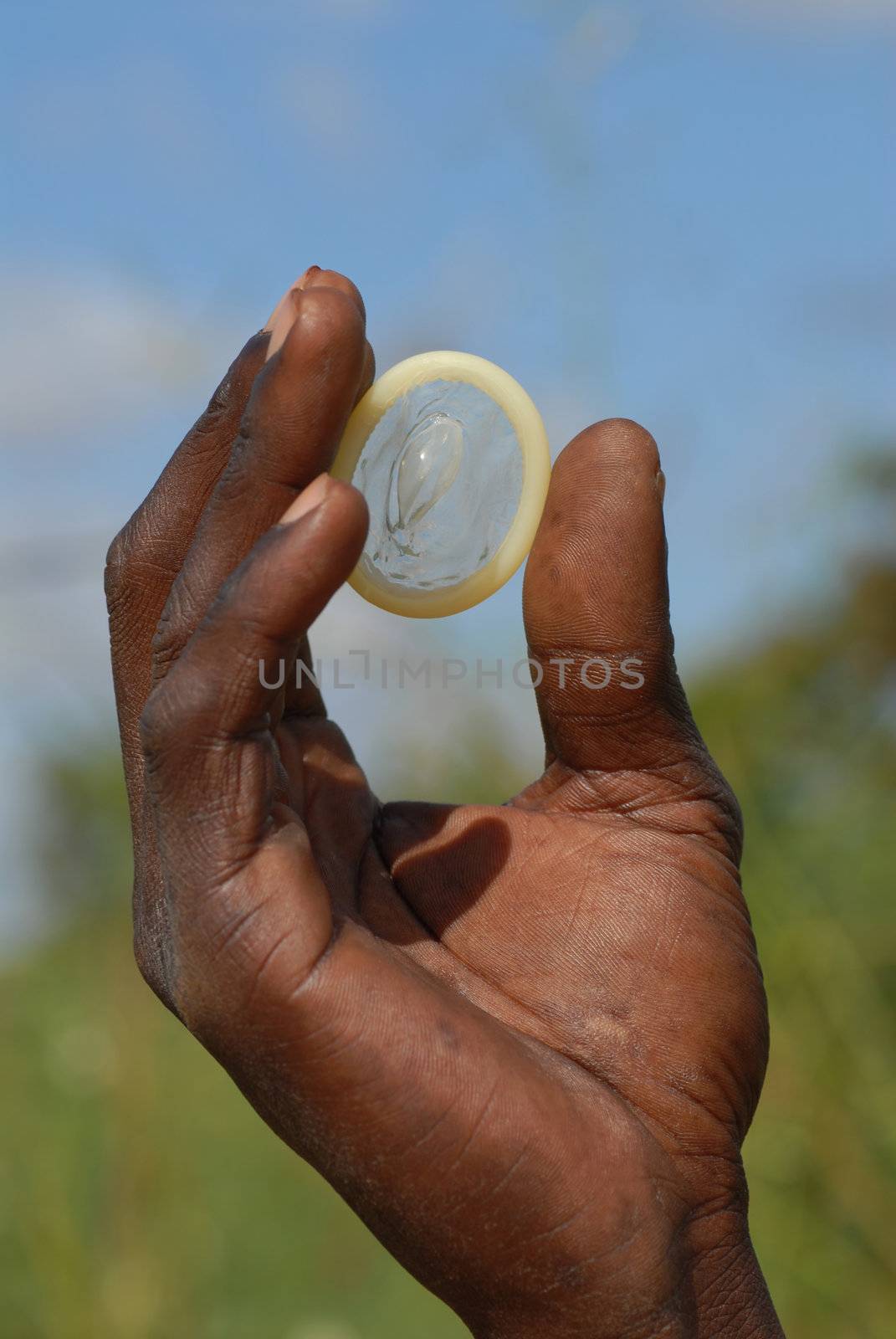 condom in the hands of an African