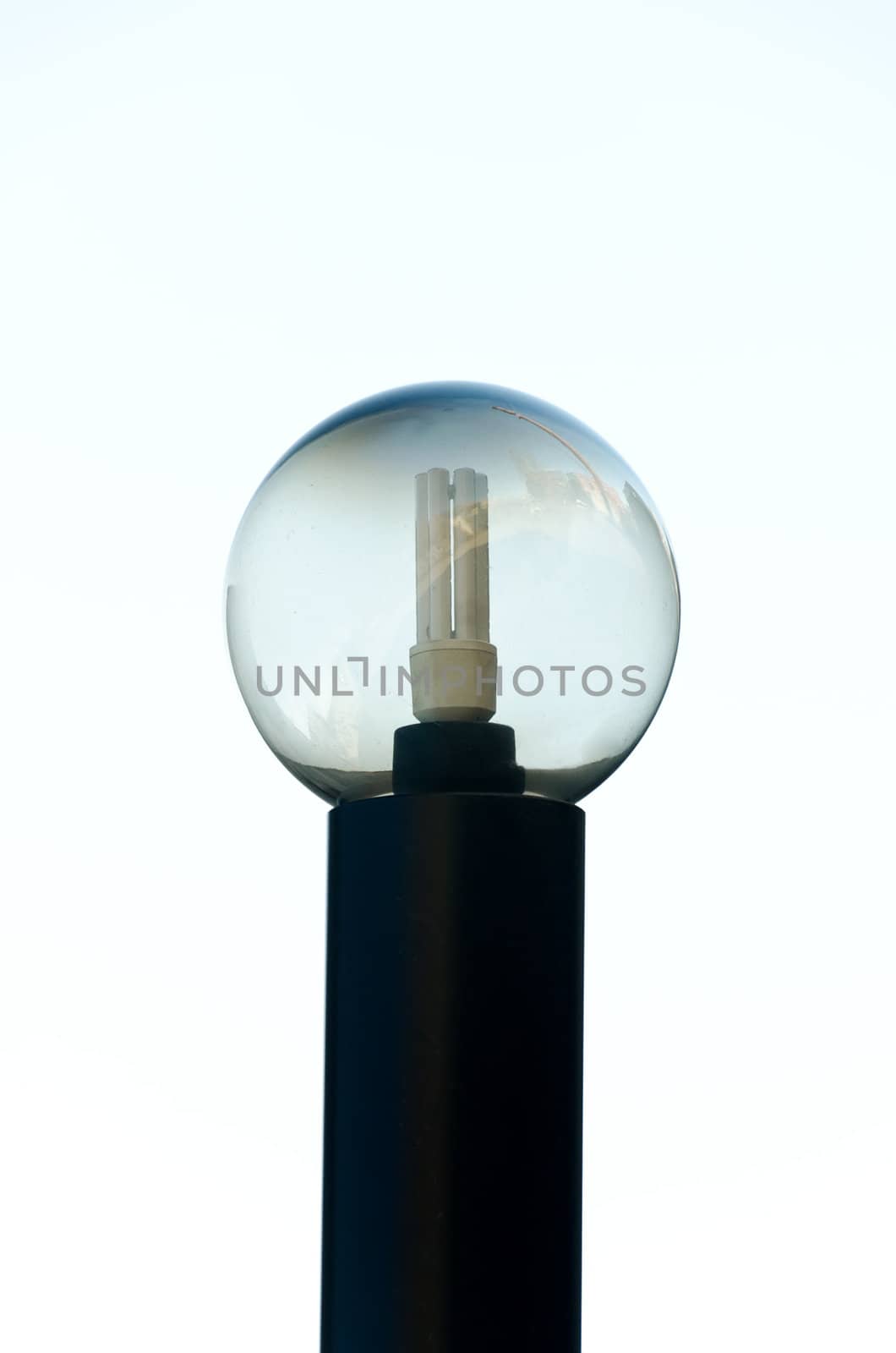 Saving light bulb in a glass sphere with city reflection