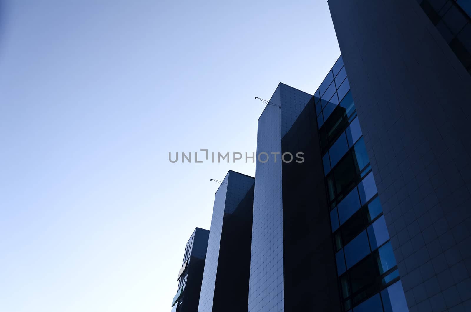 Office building under blue cloudless sky