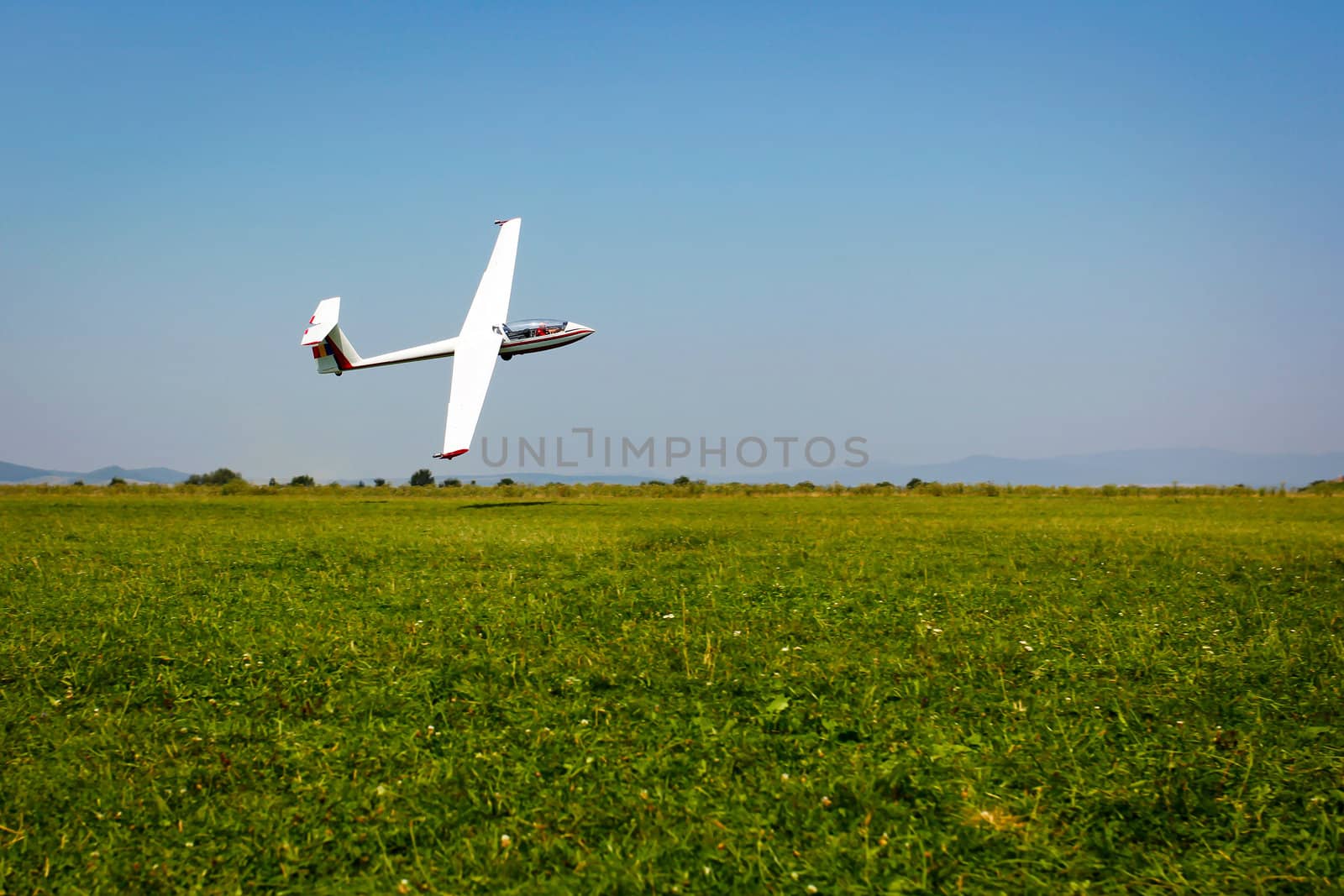 Glider flying on a blue sky