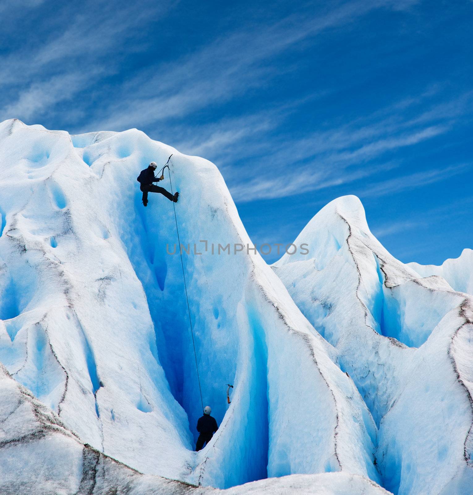 Two men climbing a glacier in patagonia. Copy space.