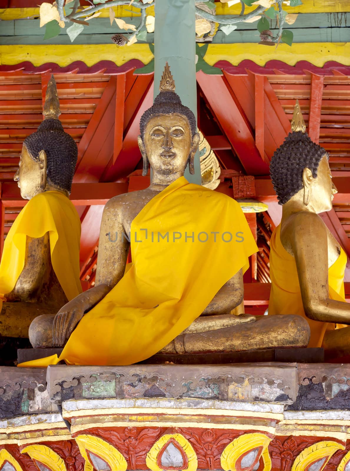 Three golden sitting Buddha  in temple , Thailand.