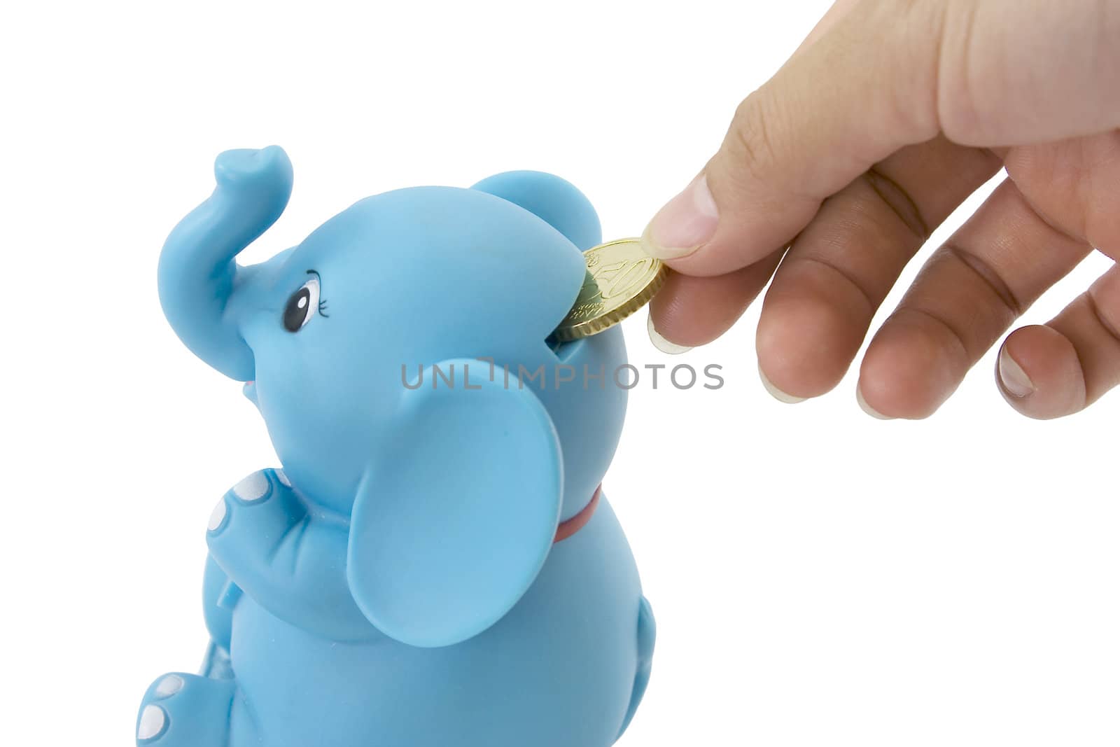 Saving money  concept by putting a coin into a elephant bank.