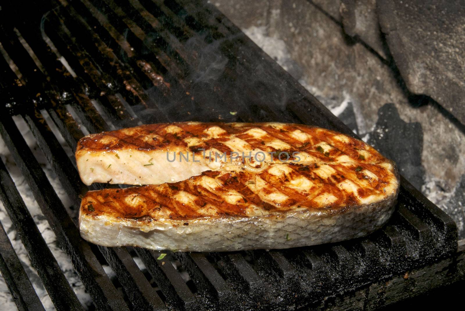 Salmon steak cooked on a grill in the restaurant